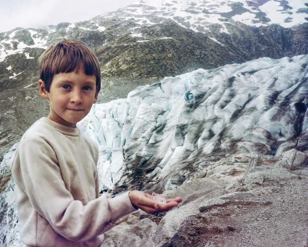 Andrew Aveling as a child in front of a glacier.