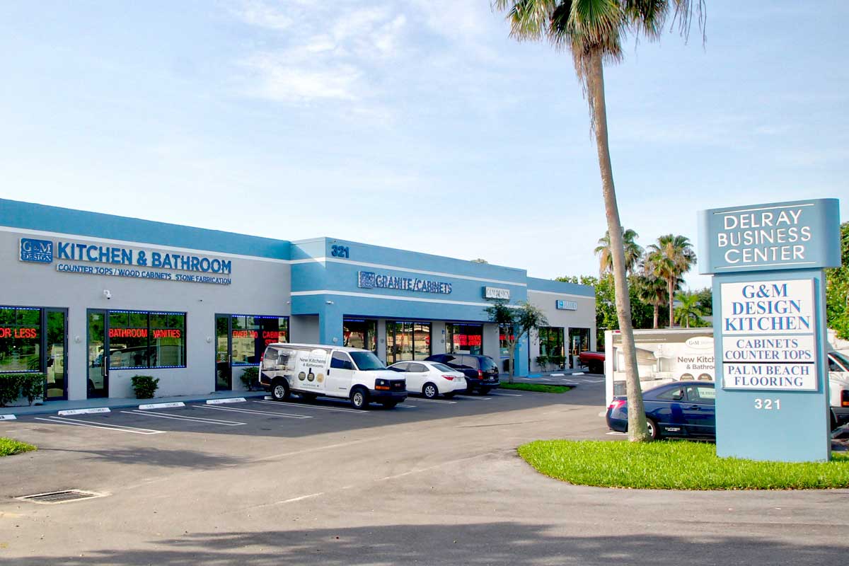 GM Design Blue building with cars parked in front.