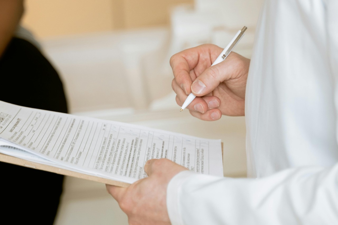 A person filling a review form in a dental clinic for reputation management. 