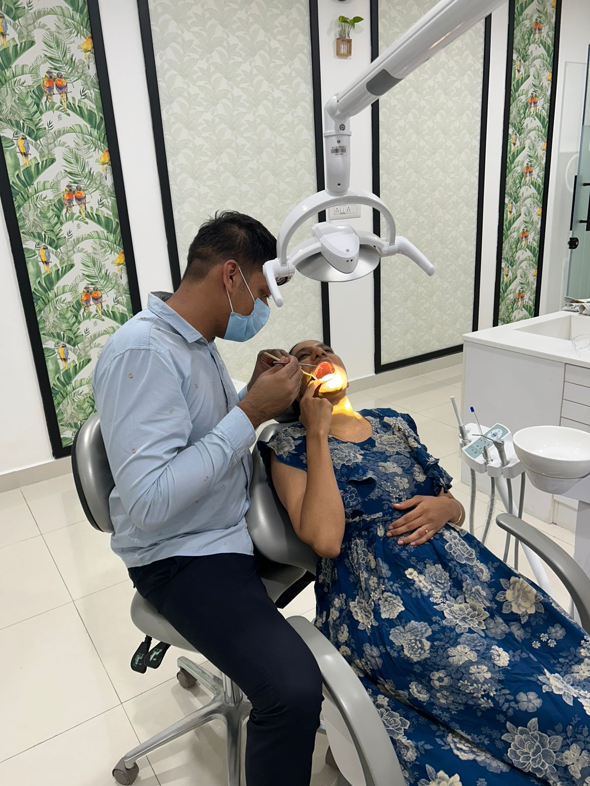 man in blue crew neck t-shirt holding white printer paper