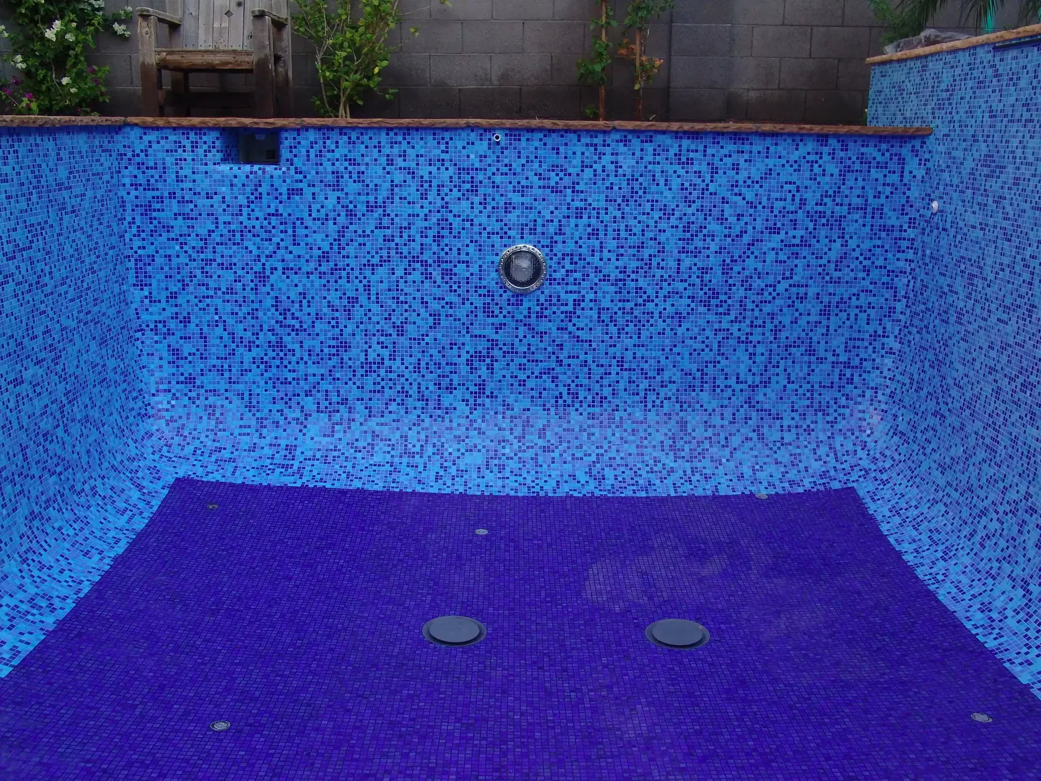 Mosaic tiled pool featuring intricate blue mosaic artwork at Mosaiclegs Art Studio.