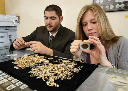A young Dave and his wife learning to sort and handle gold coins in the family business.