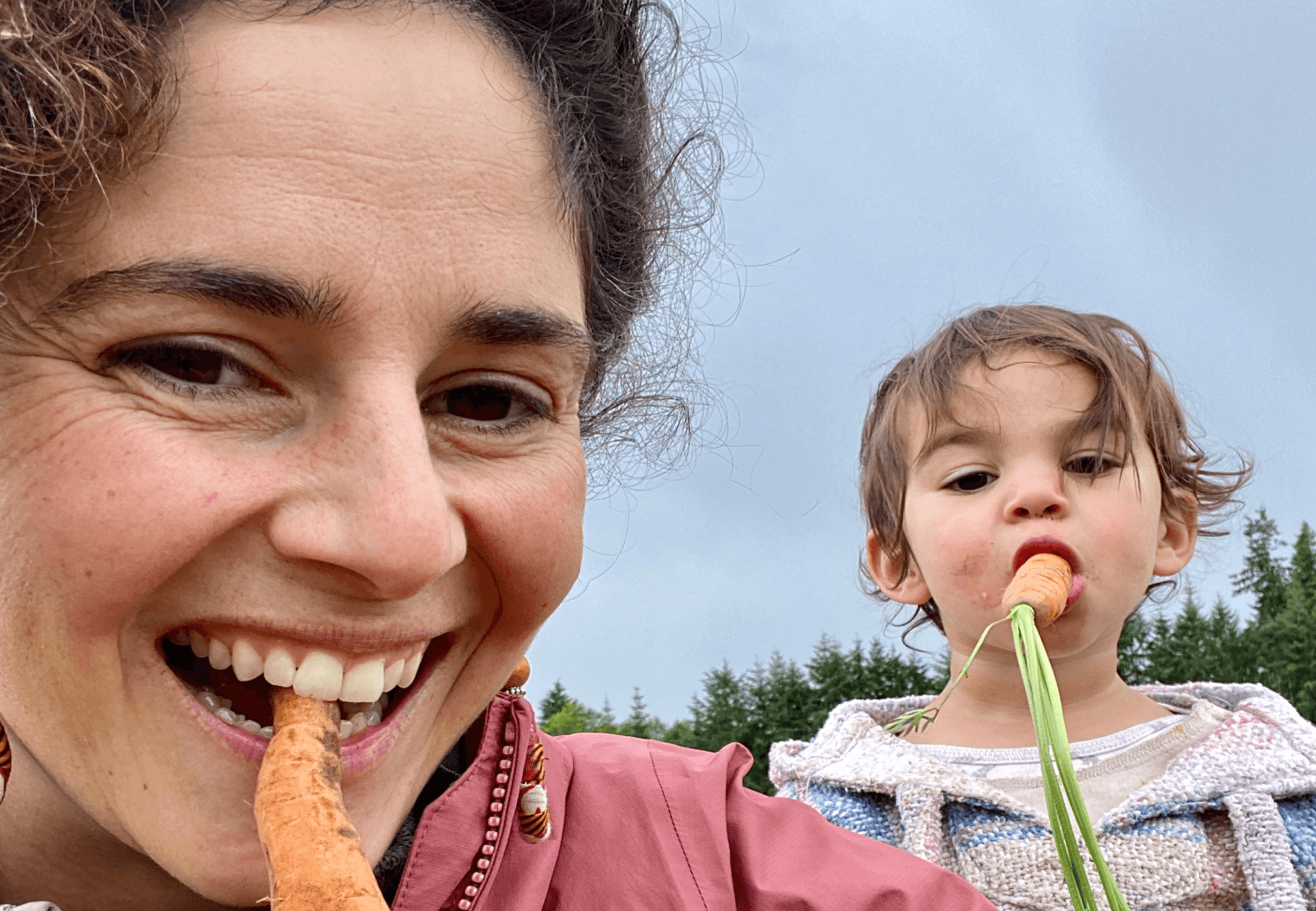 A resident sharing a lighthearted moment with a child outdoors.