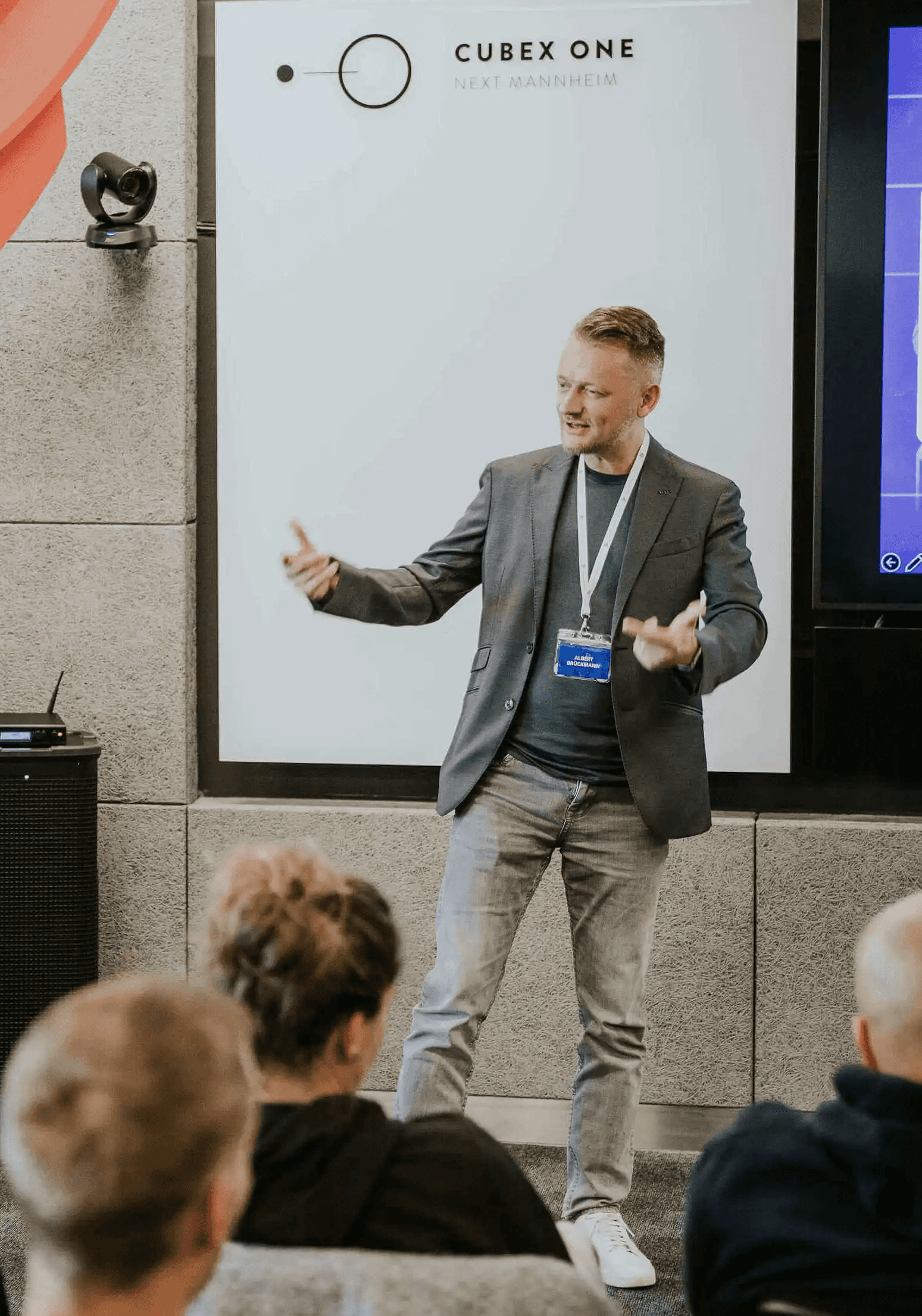 Speaker hält Vortrag vor Publikum bei Konferenz in modernem Veranstaltungsraum