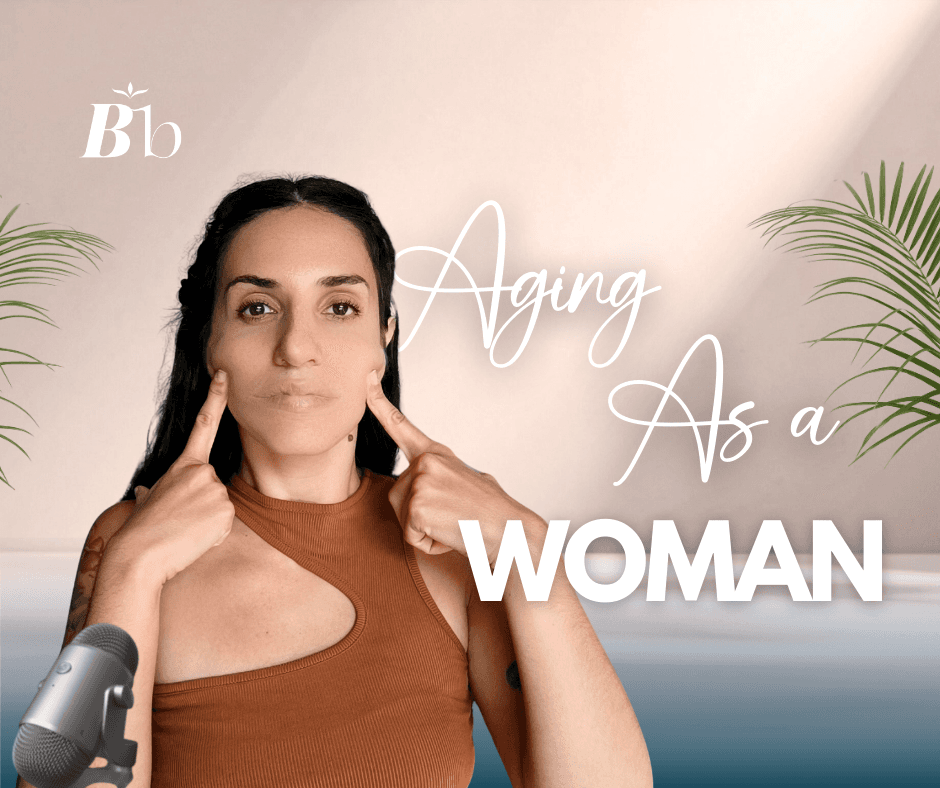 A woman is standing, looking worried, staring at the camera, strecthing her cheeks to lift her skin. The caption reads "Aging as a woman"