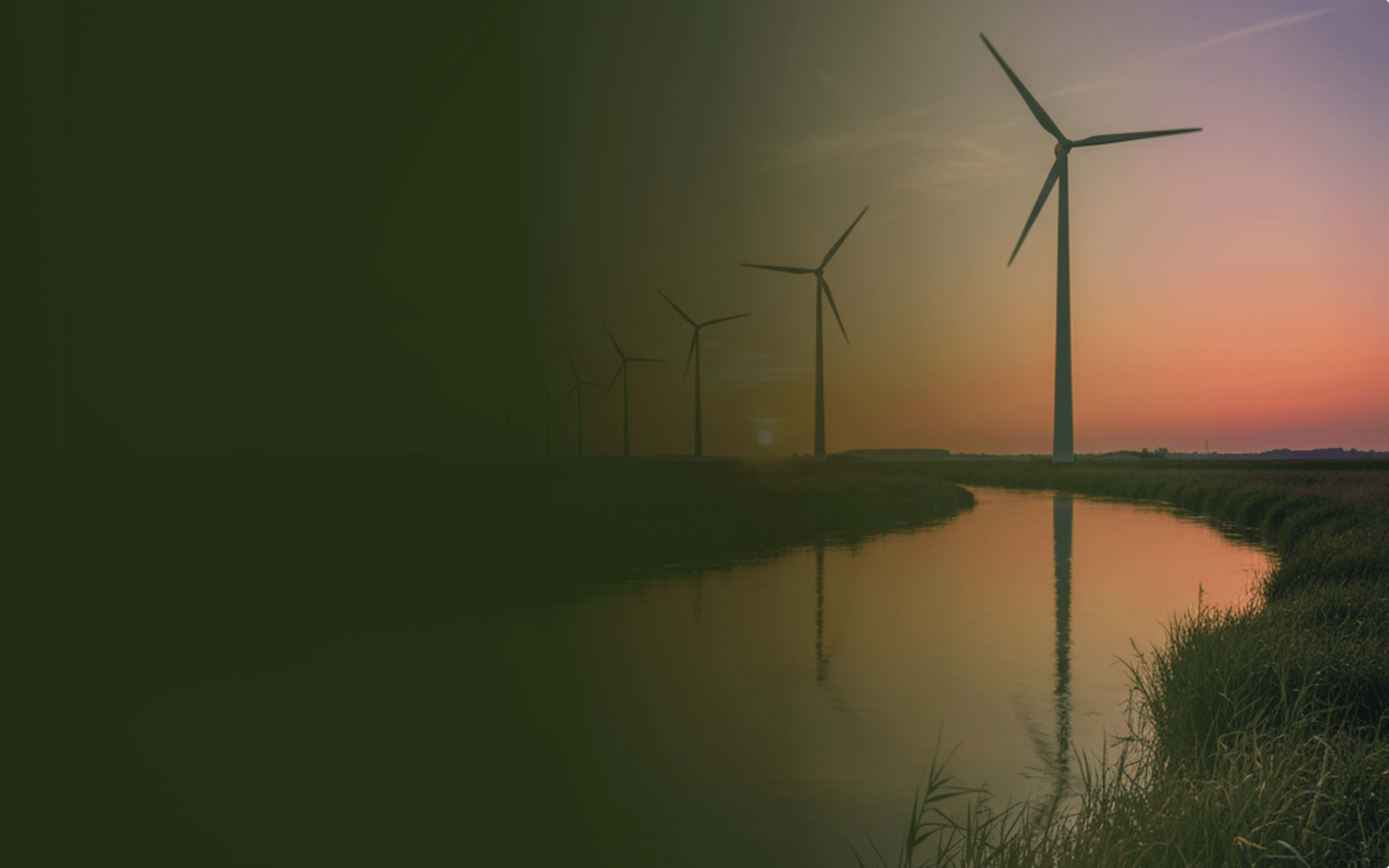 Wind turbines at sunset reflected in a calm river.