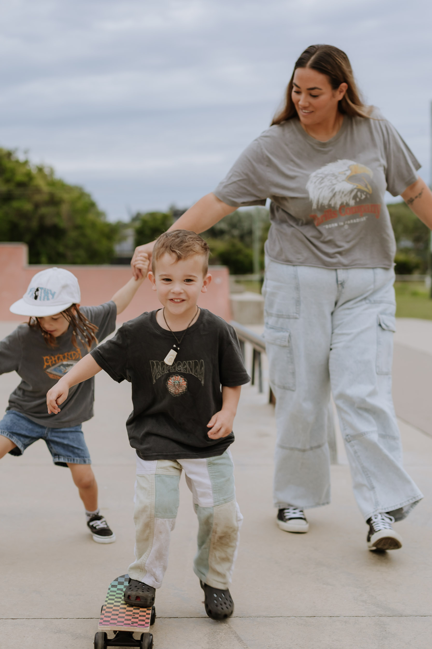 Family skateboarding together at a Mackay skate park during a relaxed outdoor family session