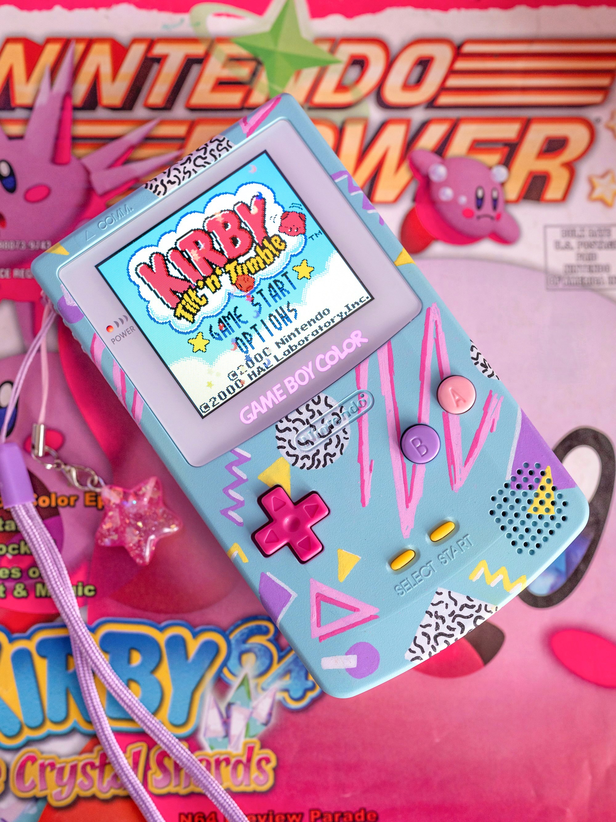 Hand-painted Game Boy Color on top of a Nintendo Power magazine