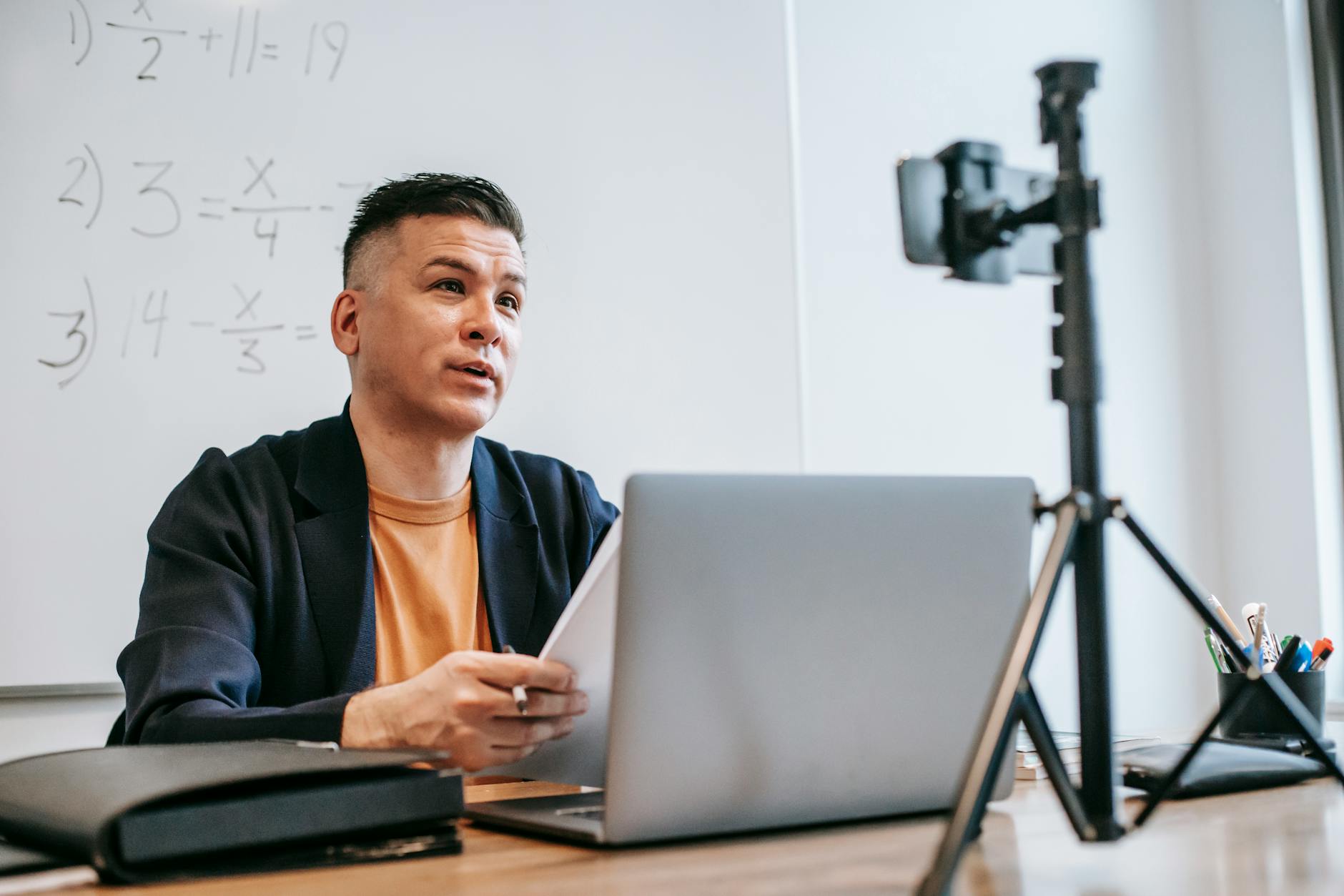A wall-mounted 360-degree camera and a tablet displaying a live video feed of a classroom observation.