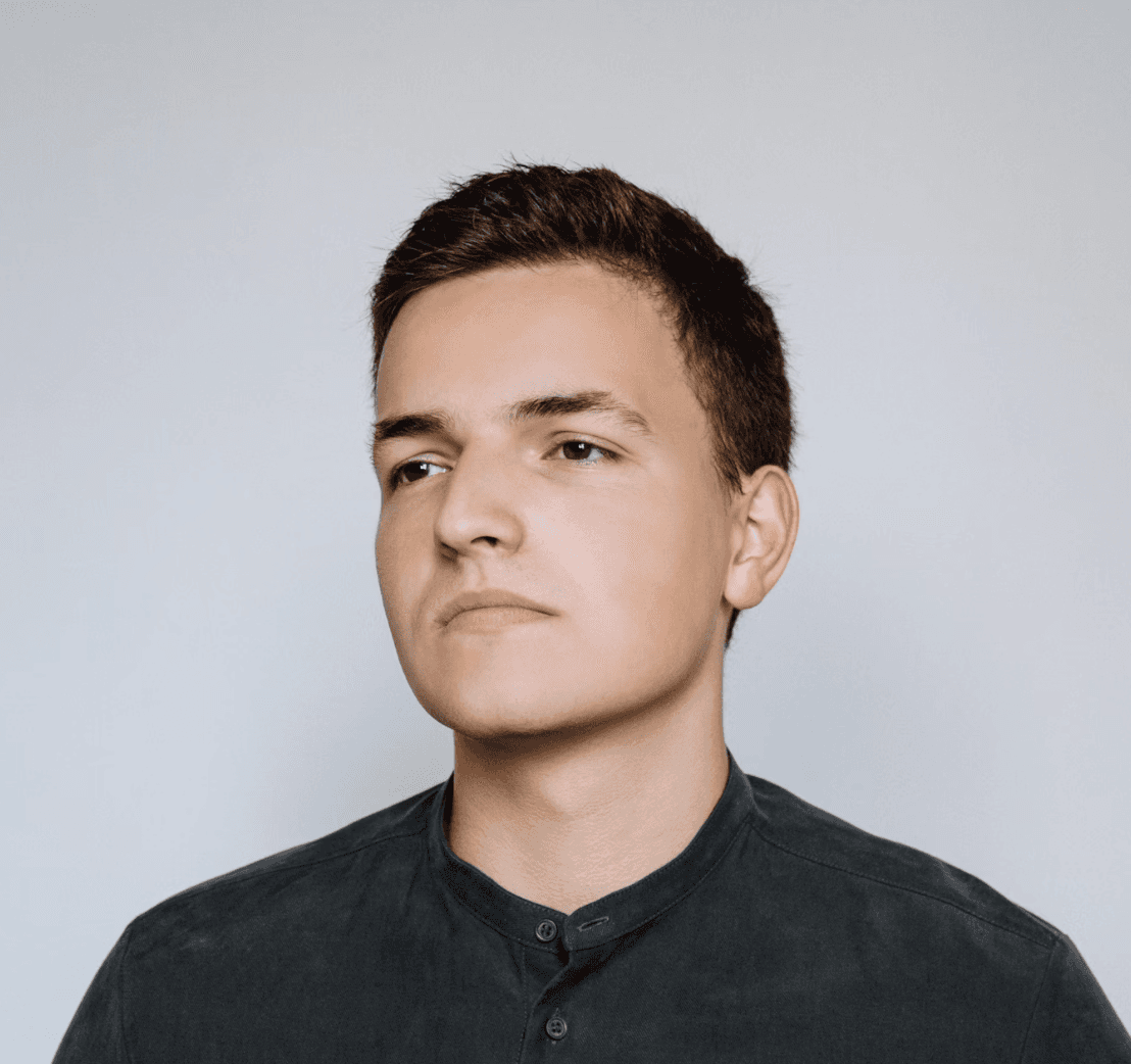 smiling woman wearing white and black pinstriped collared top