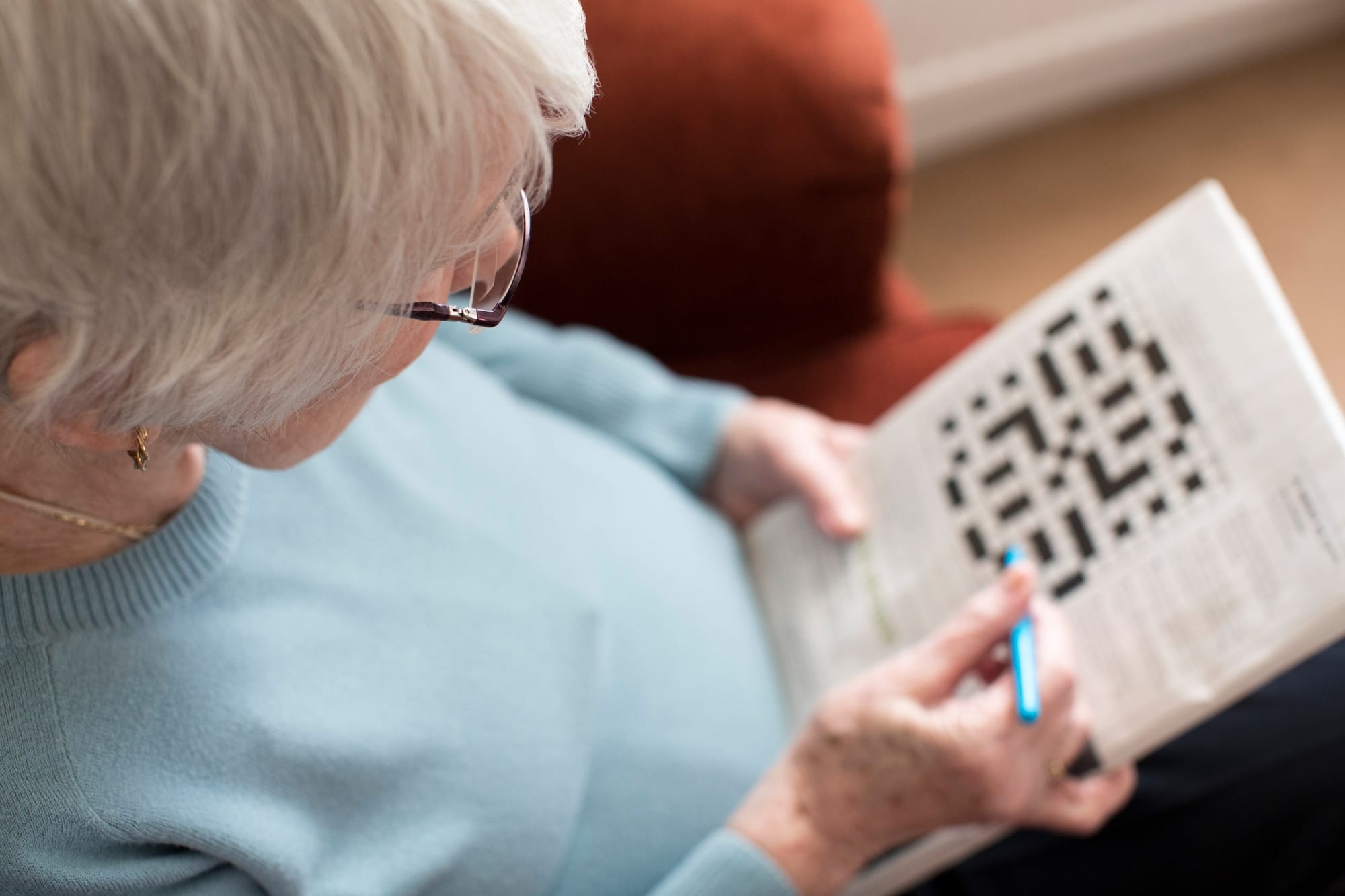 Older woman completing a crosswork to promote brain health, function and reduce dementia risk