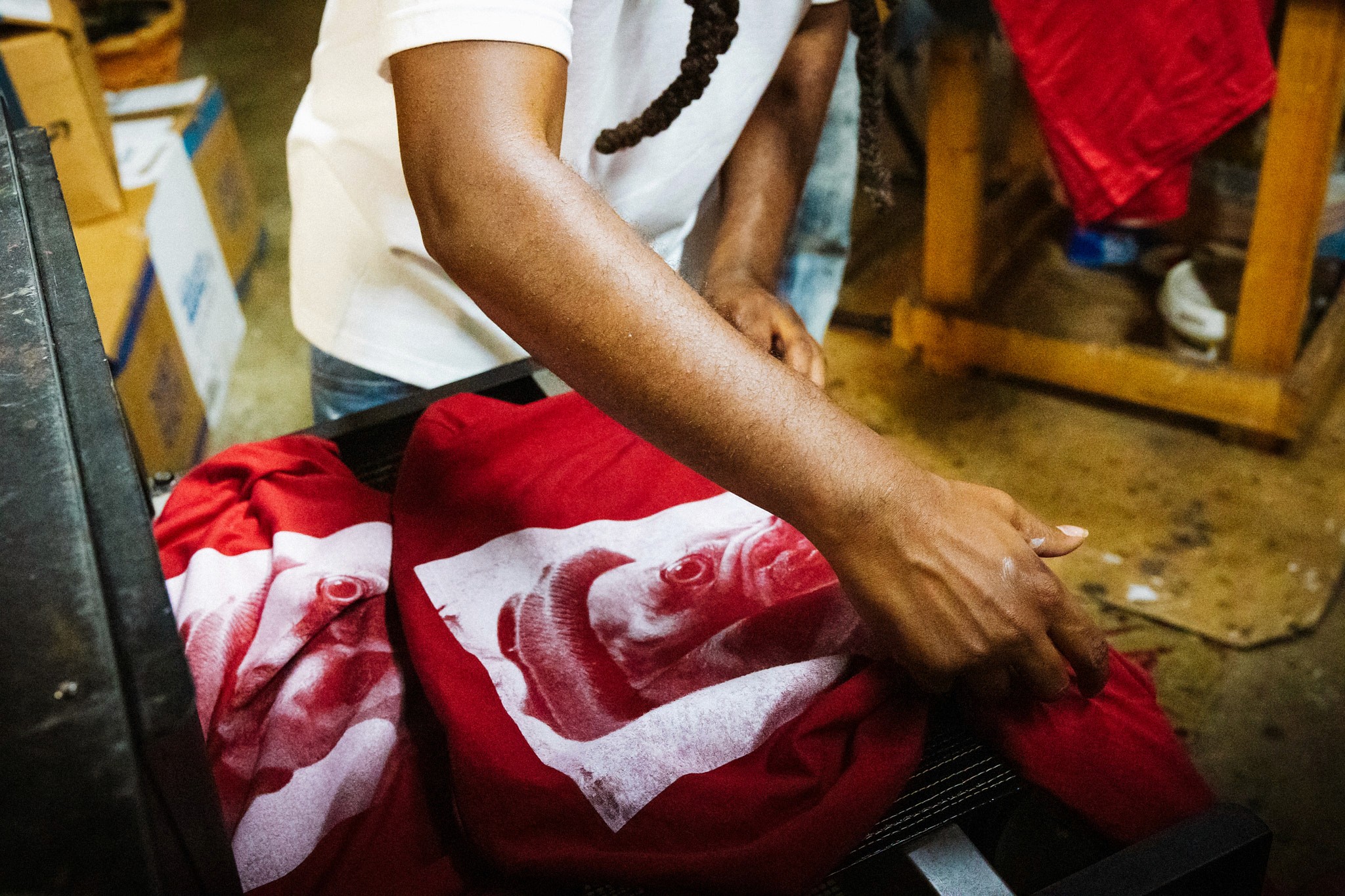 small business owner folding shirts