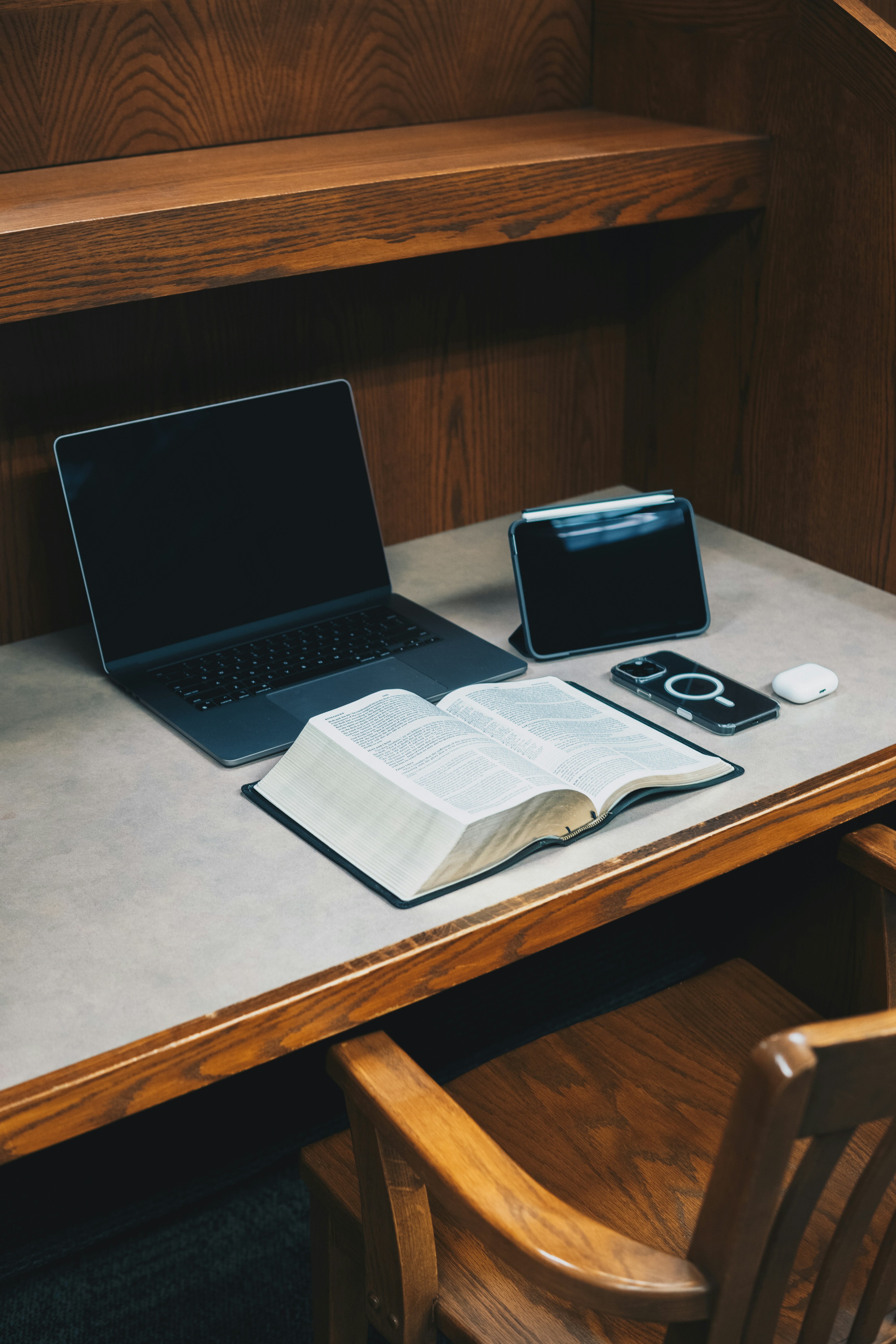 A laptop computer sitting on top of a wooden desk
