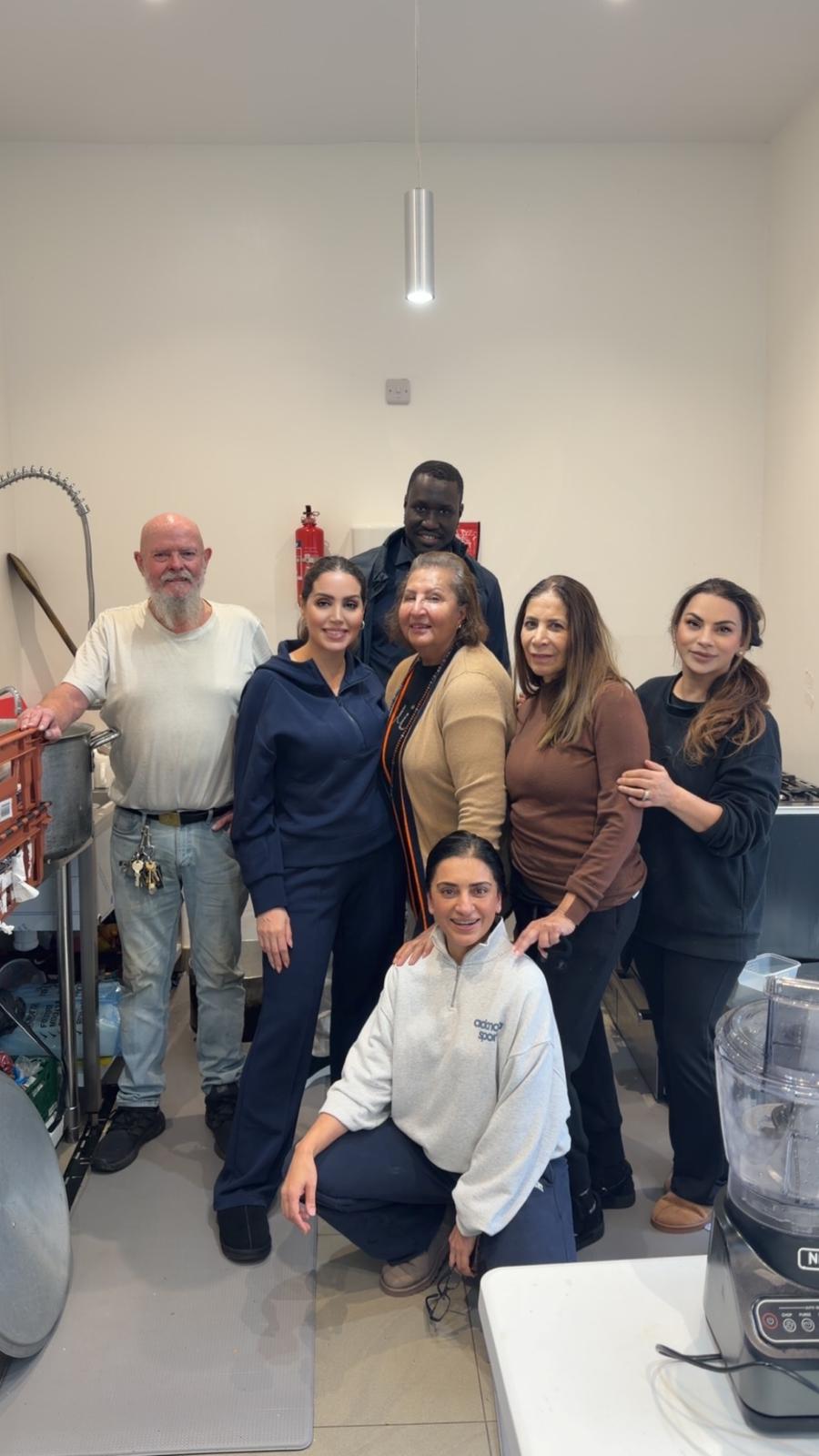 man in black crew neck t-shirt and blue shorts holding woman in white and red