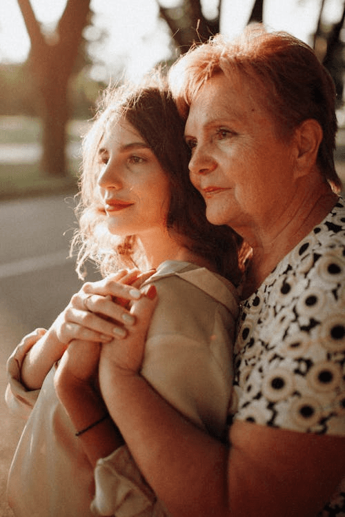 a group of people holding hands in front of trees