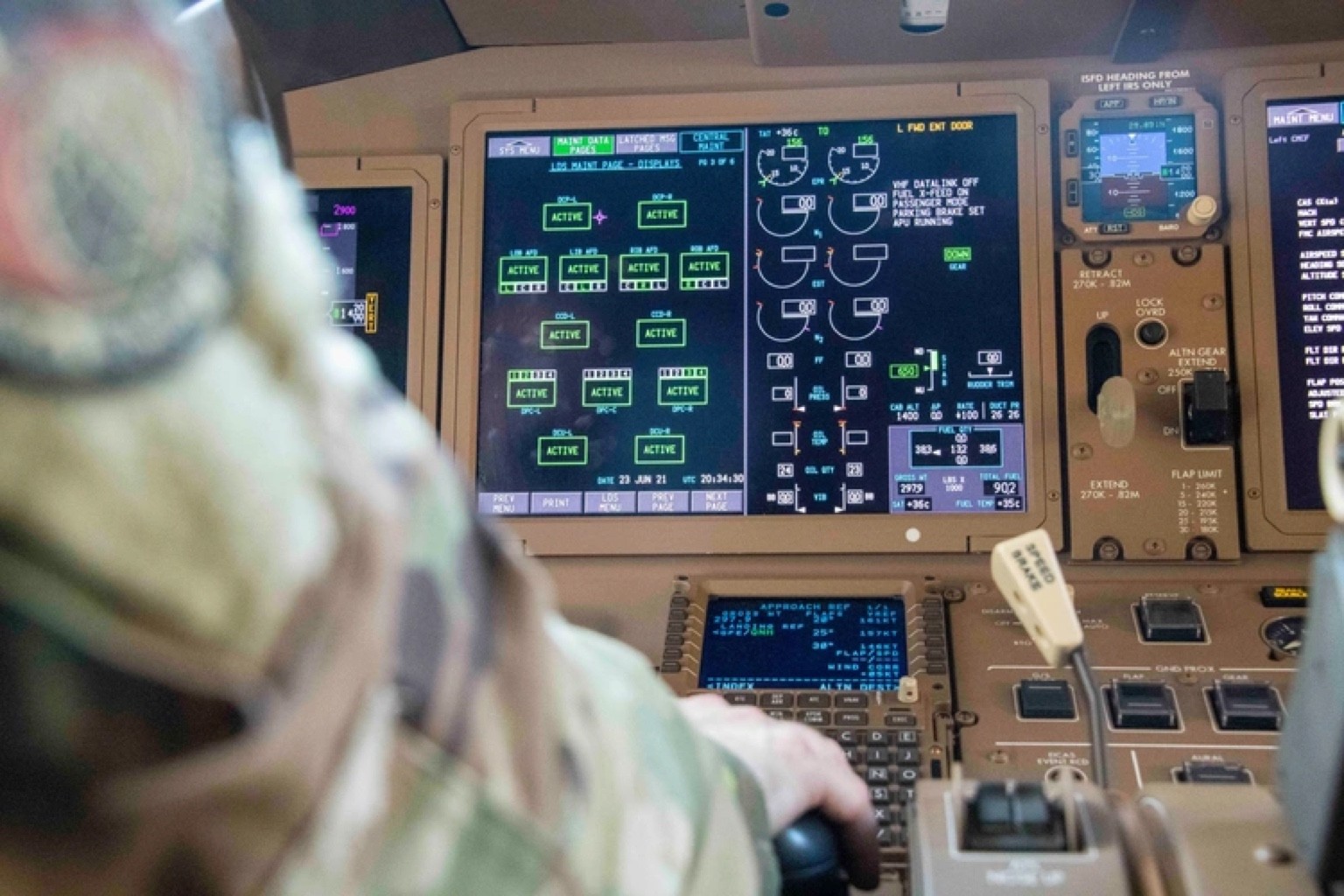 A crew member at the controls of a KC-46A flight deck