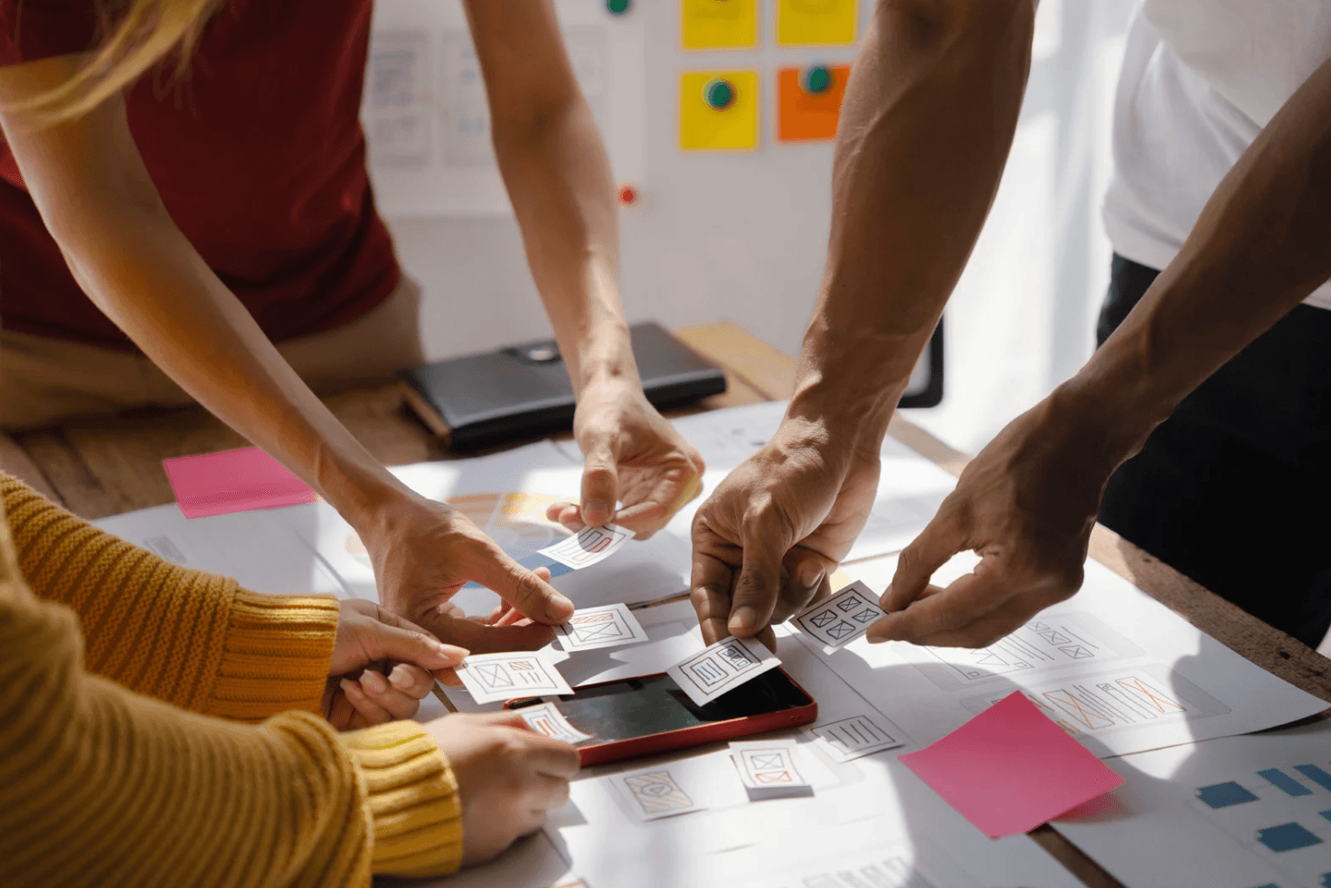 Team collaborating over UX planning cards, reflecting Autron’s coordinated, cross-campaign logic that improves Amazon scaling performance.