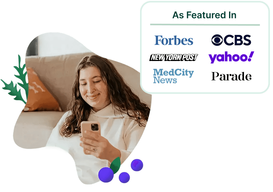 Woman smiling at her phone learning her nutrition therapy is covered by insurance