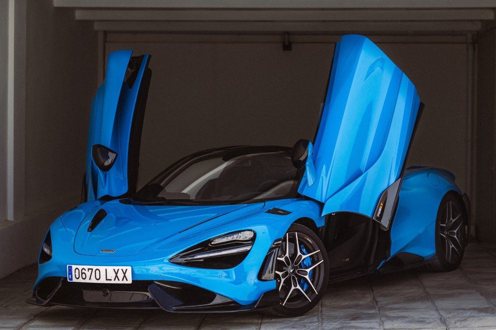 Black cosmetic product bottle against a dark background