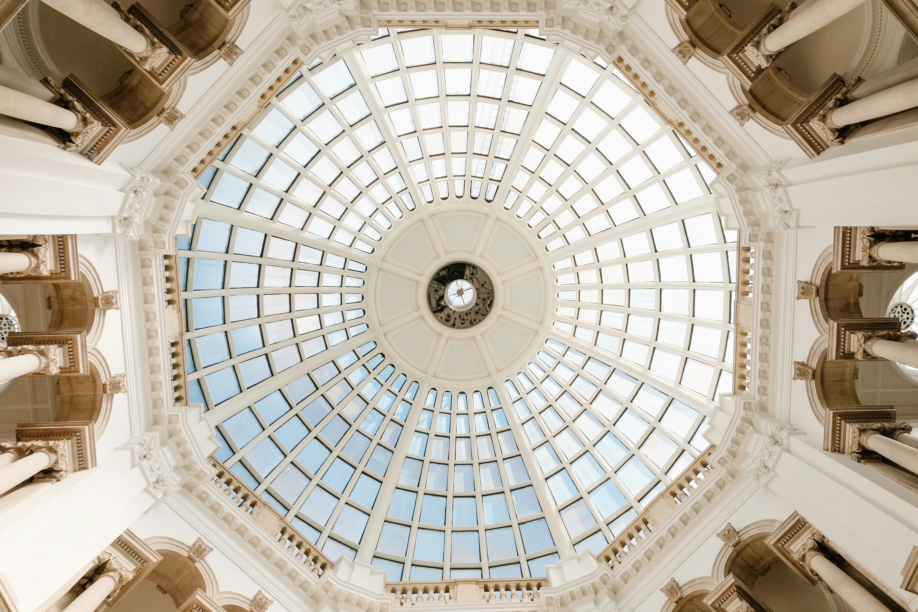Looking upward at the glass ceiling dome of the Tate Britain museum.
