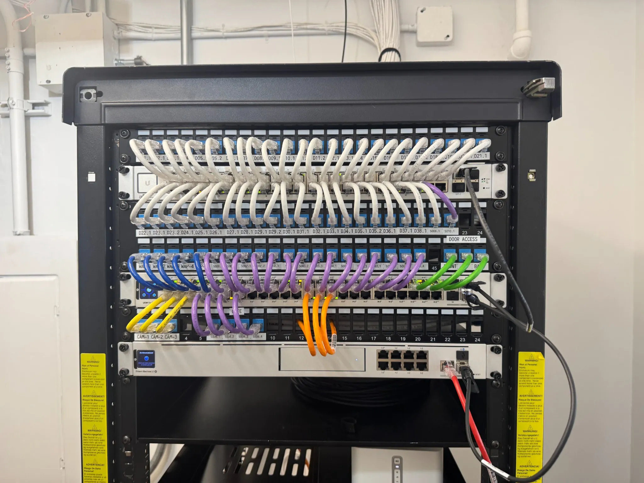 Structured network cabling with patch panels and color-coded Ethernet cables in a server rack, showcasing organized data infrastructure