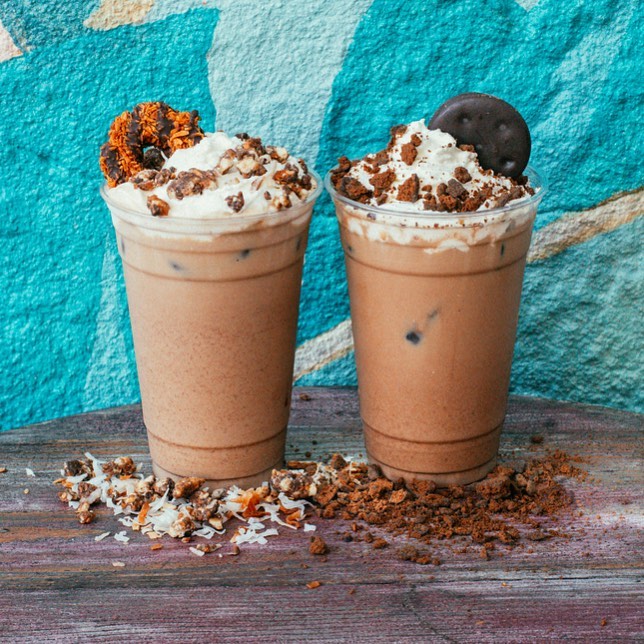 A chef placing fried chicken in a take away box