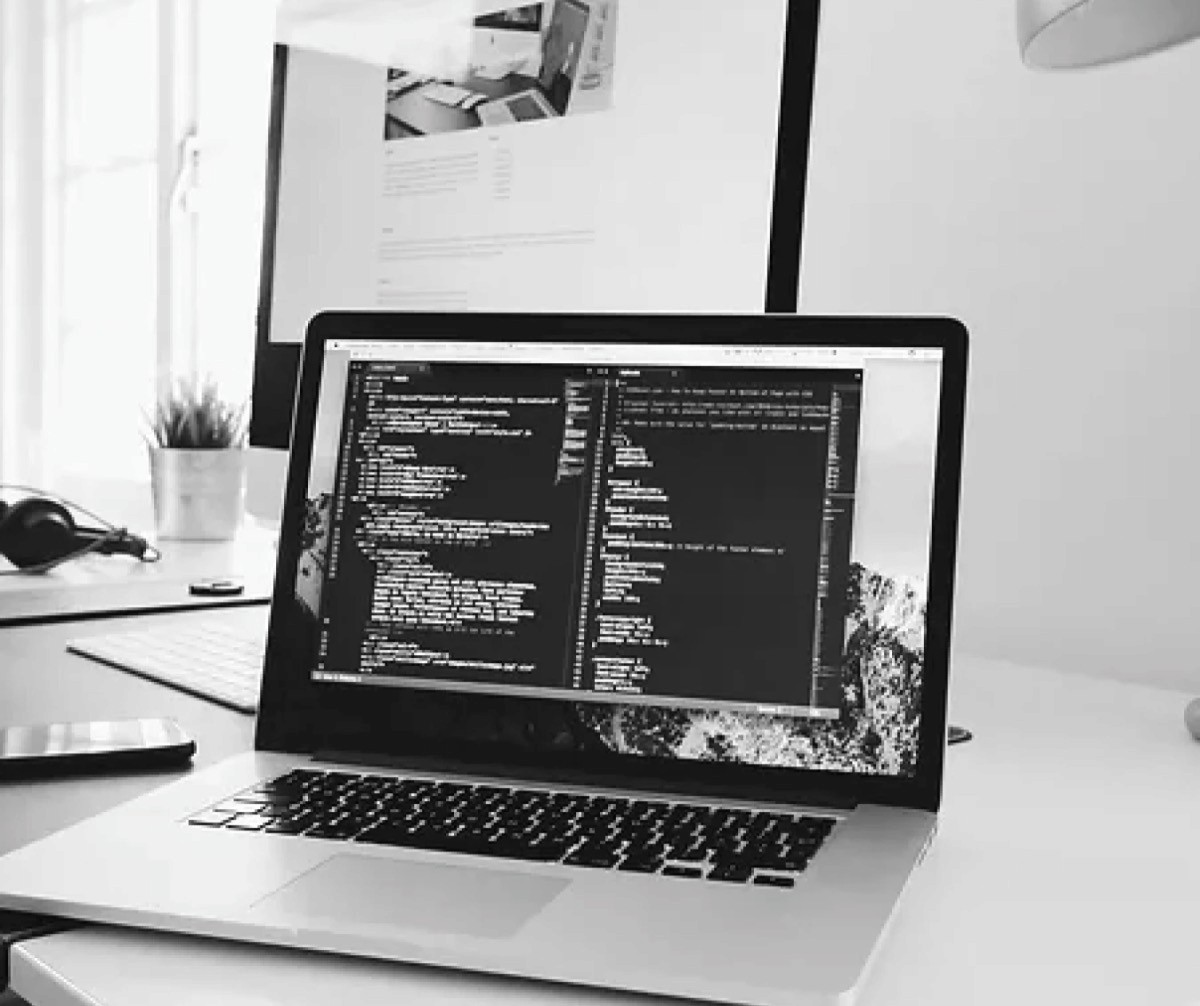 A laptop screen with a window filled with code