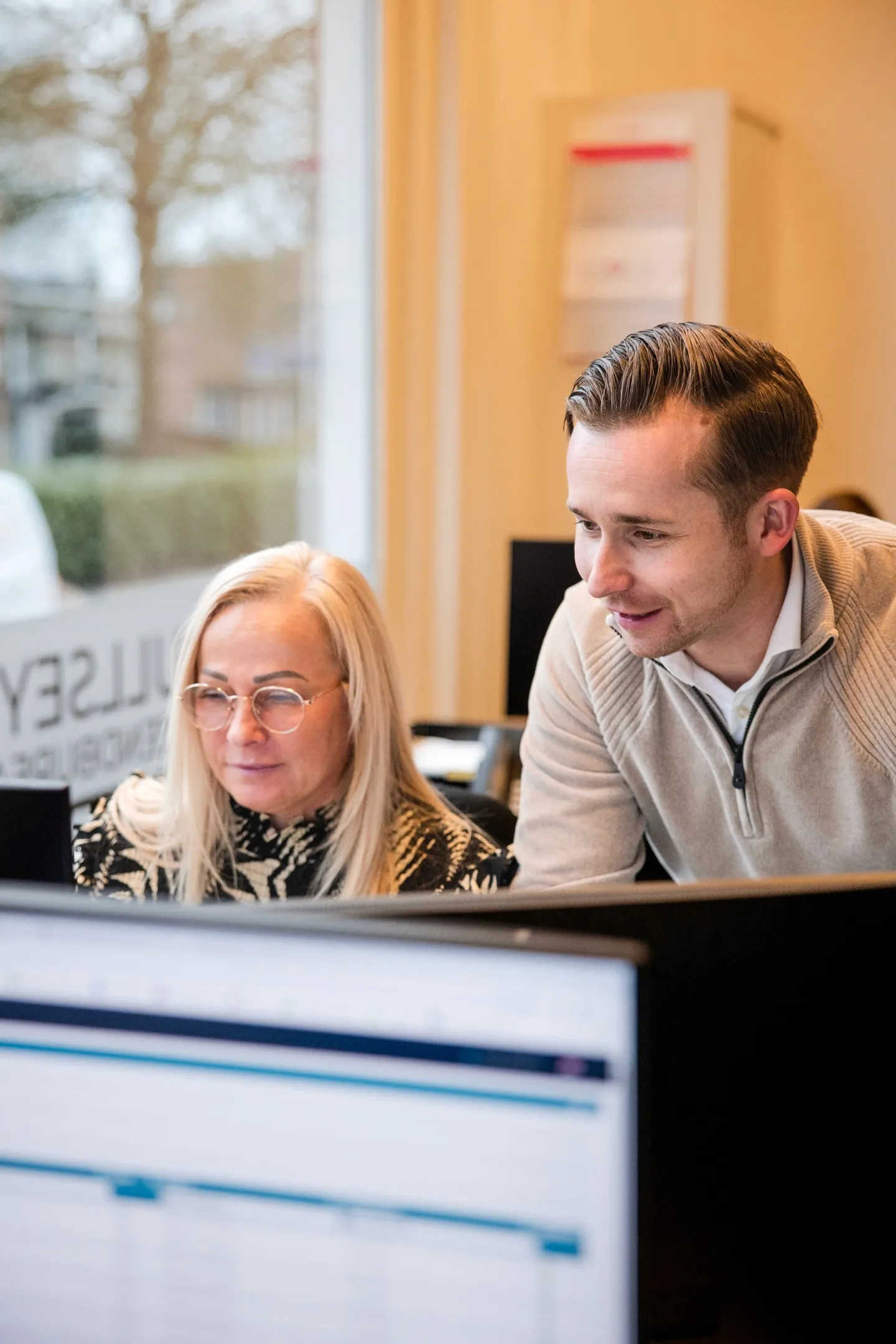 man in green and black plaid long sleeve shirt holding red and black cordless hand drill