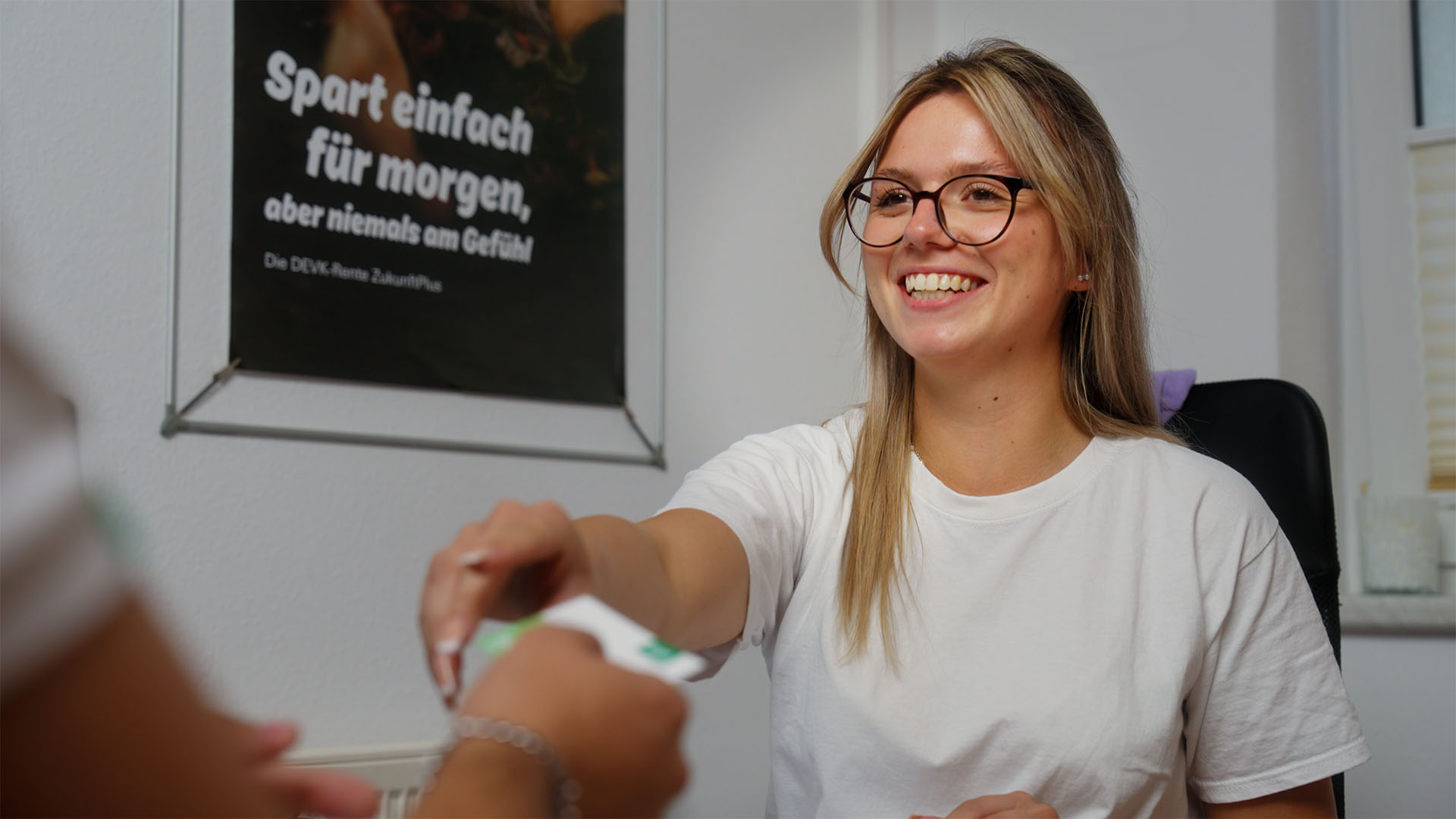 Smiling woman in an office setting, part of a filmproduction campaign showcasing effective communication and storytelling.