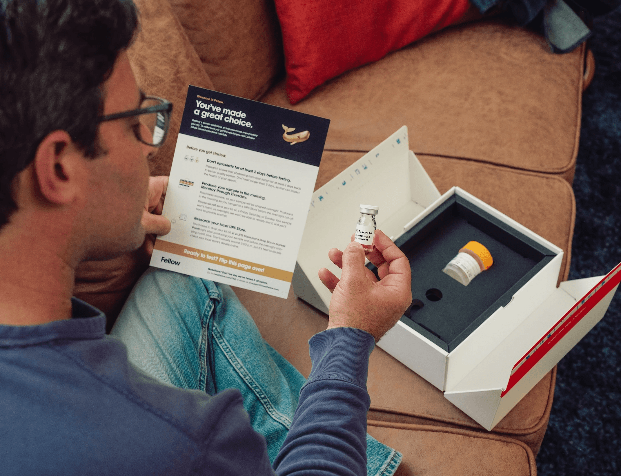 A man looks at the testing instructions for the Fellow Semen Analysis kit