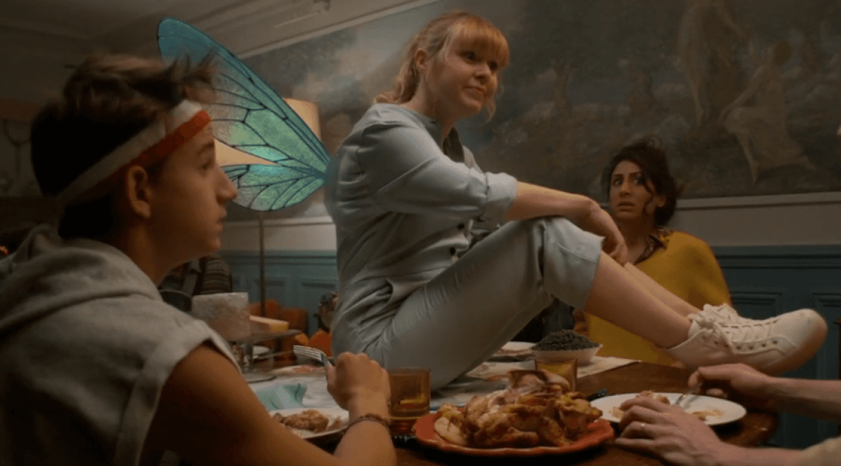 Woman wears a blue coat in a blue environment.