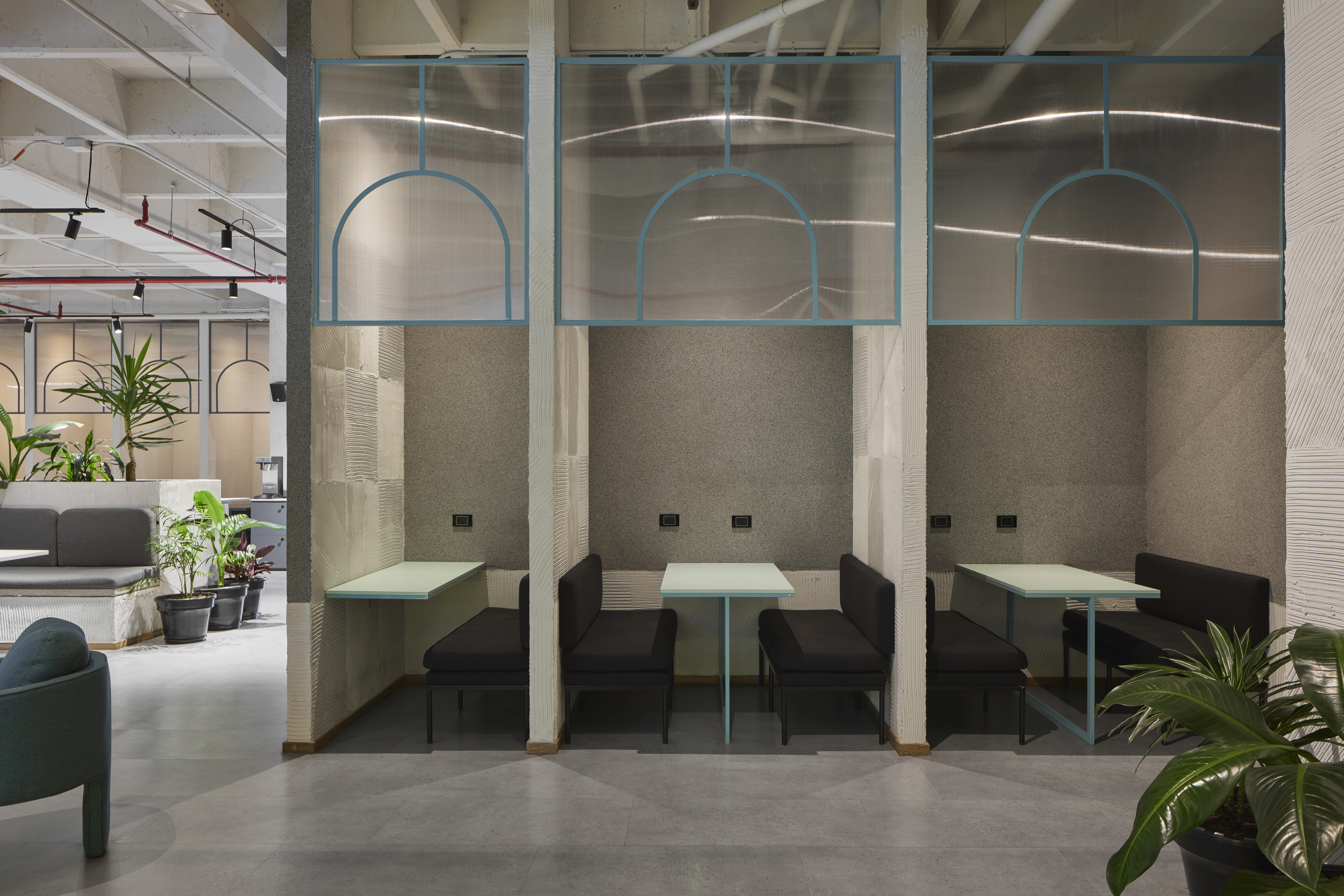 Double-height interior with flowing sculptural forms and warm raking light