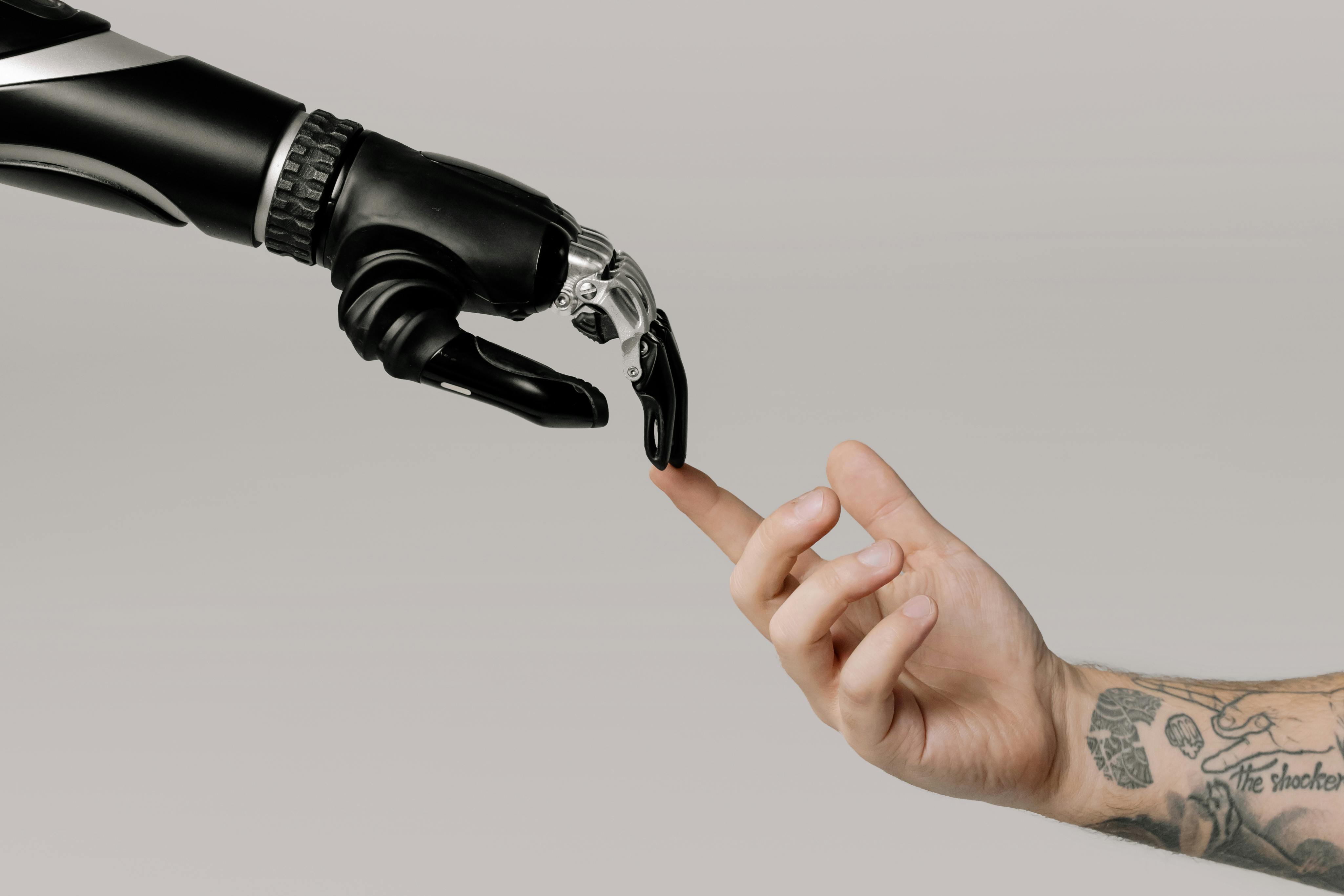  A robotic hand extends towards a human hand, symbolizing the connection between AI and humanity.