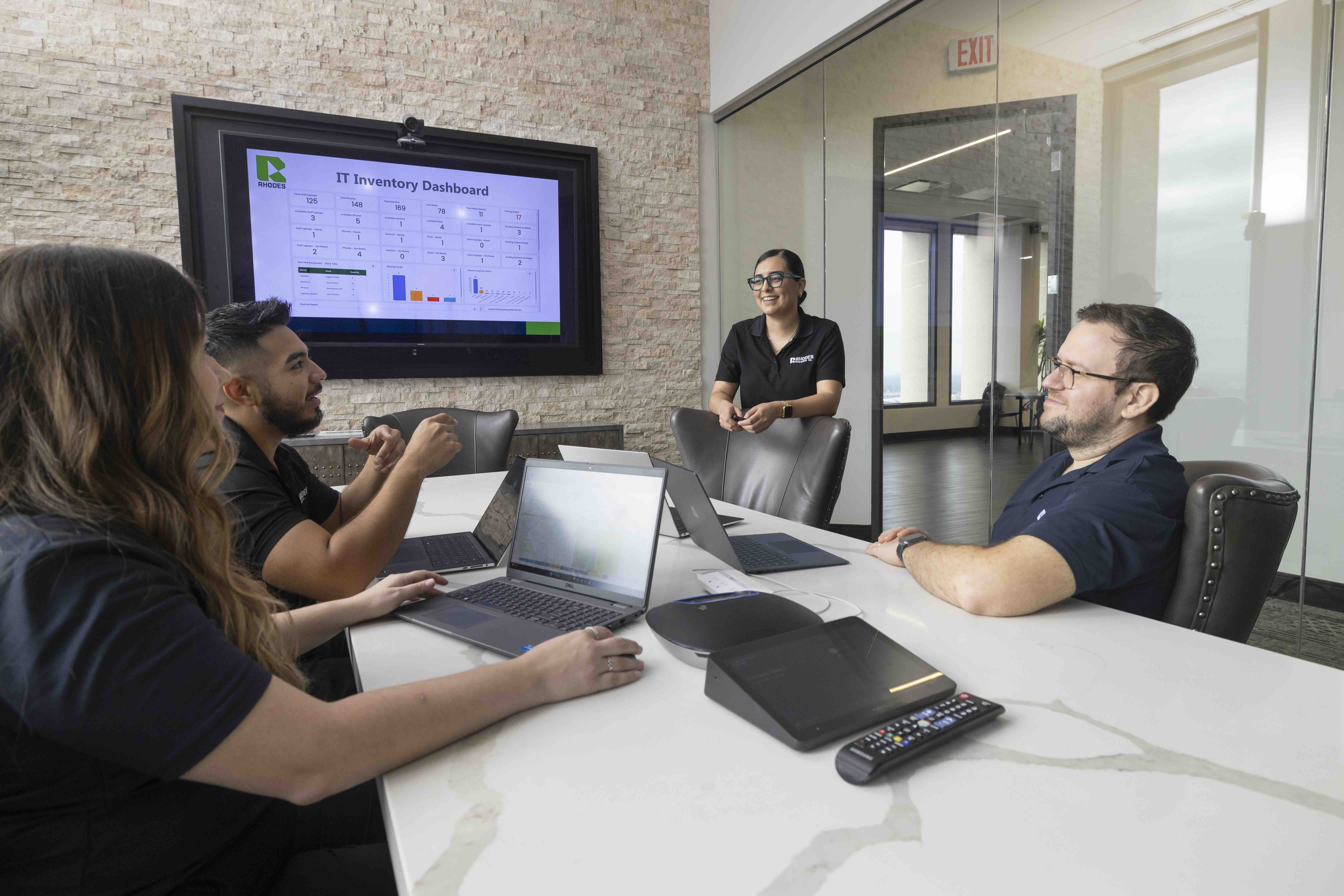 Rhodes Enterprises IT team collaboration meeting with inventory dashboard at McAllen headquarters office