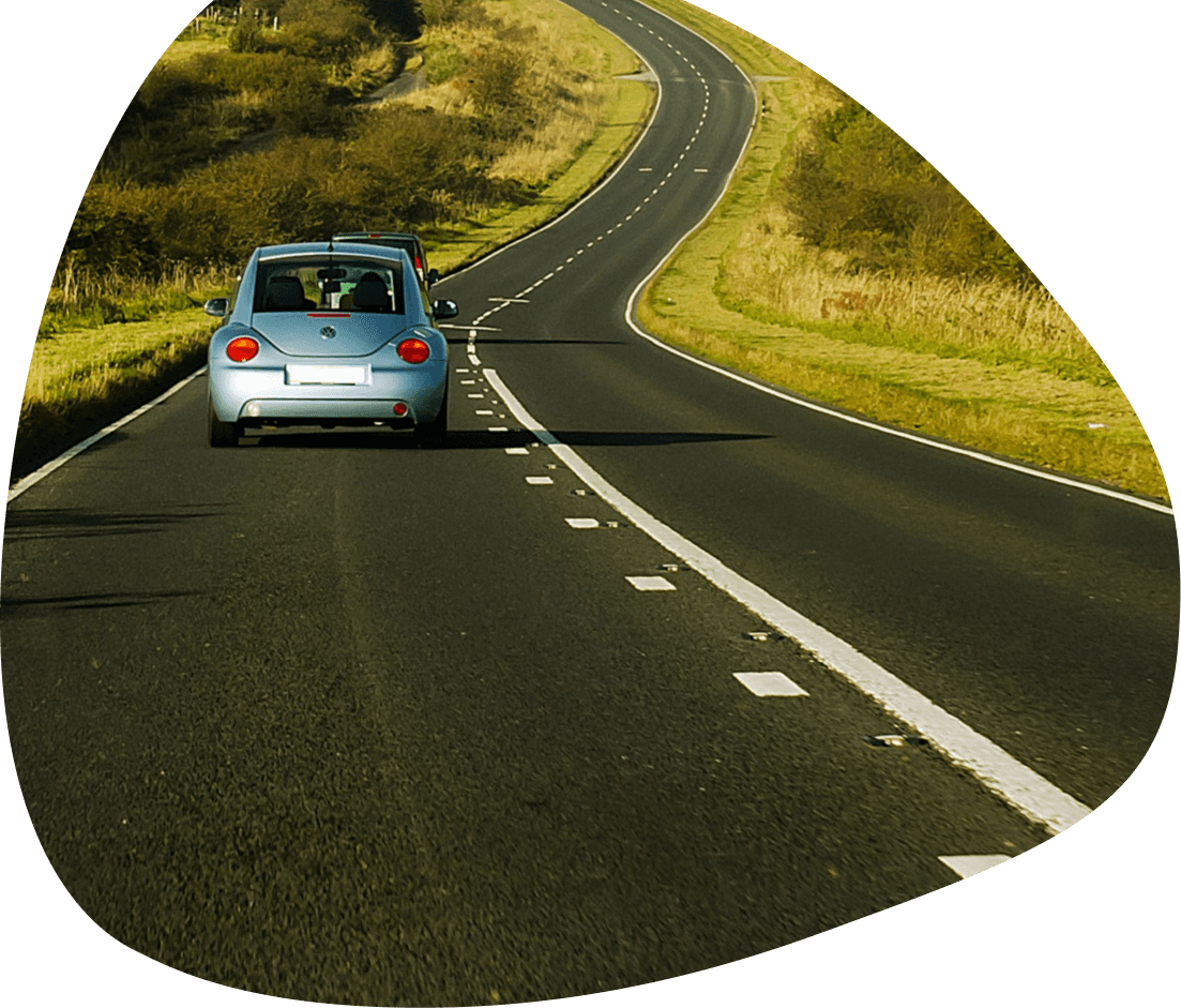 Car driving on a winding rural road in Ireland with its4women car insurance