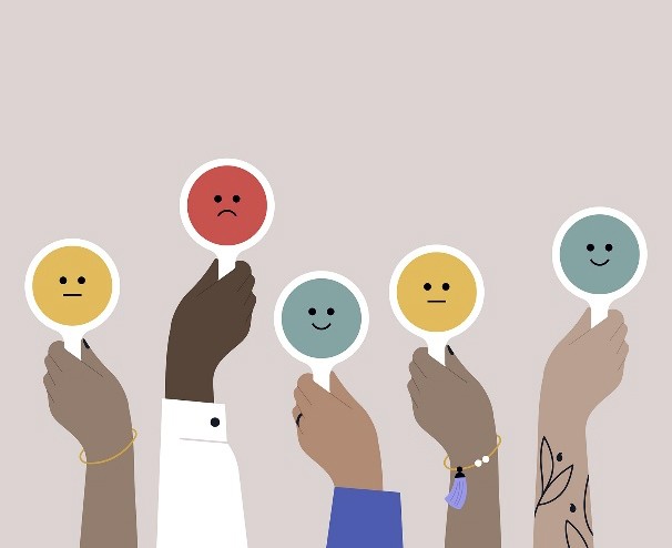 Illustration of hands holding paddles showing different emoji facial expressions