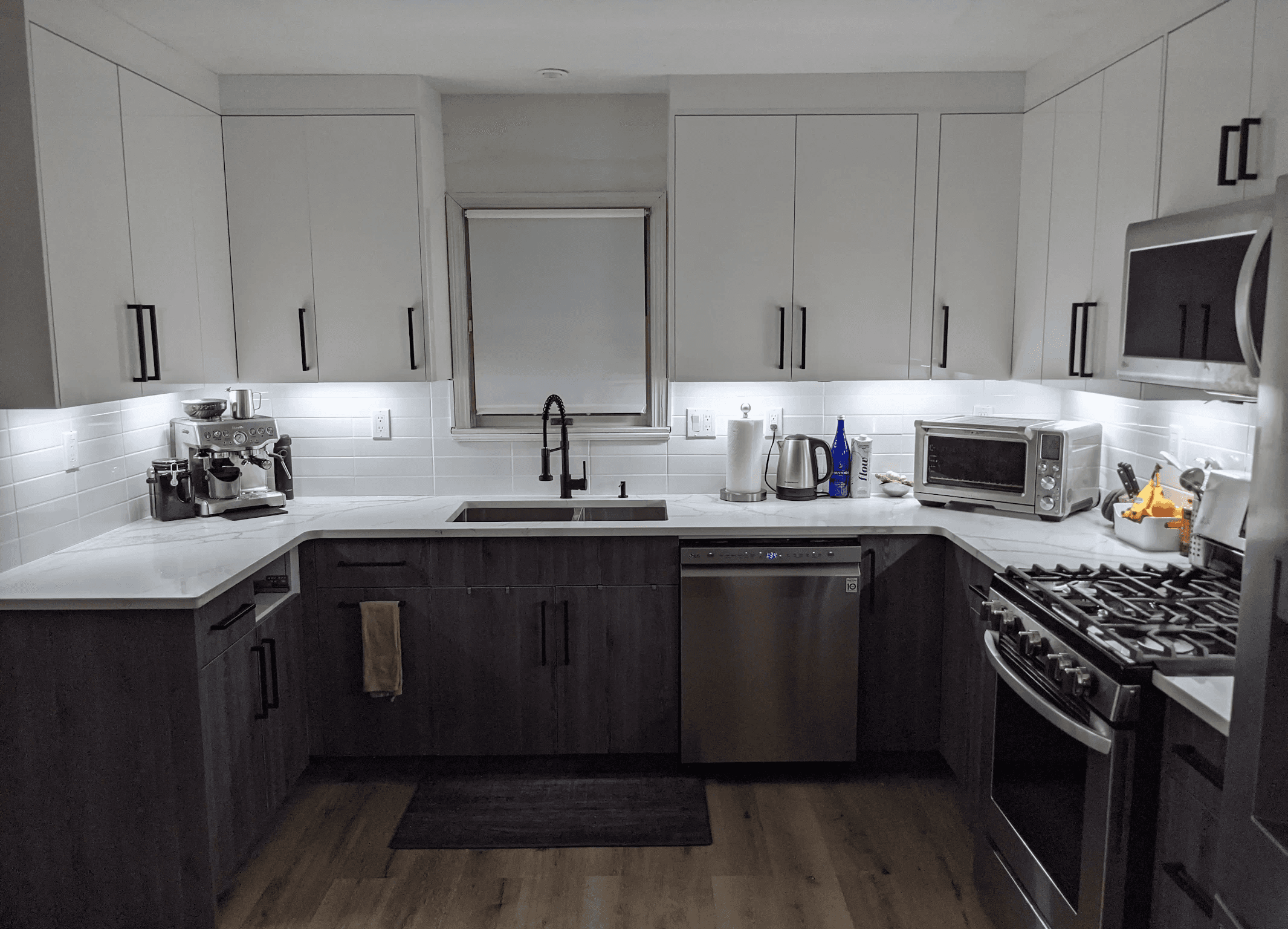 white wooden kitchen cabinet with black pendant lamp