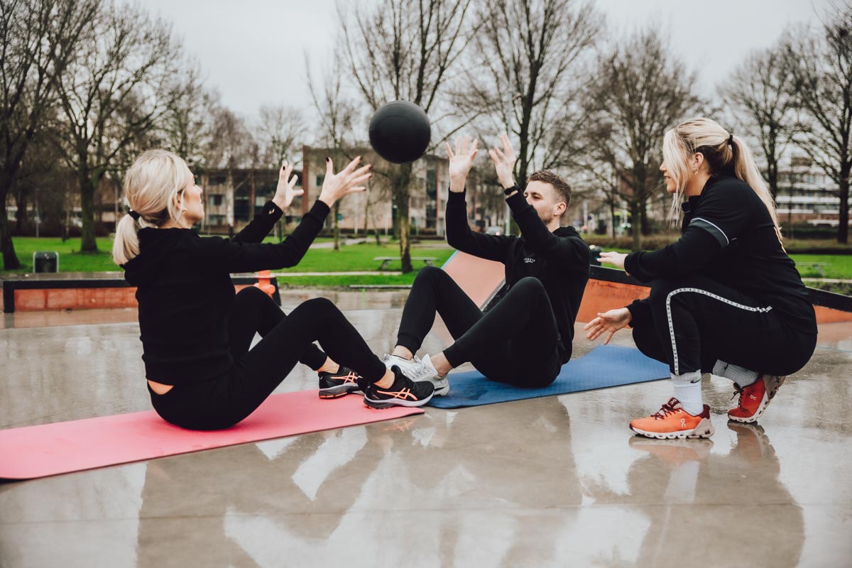 Kyra spotting client while doing press bench