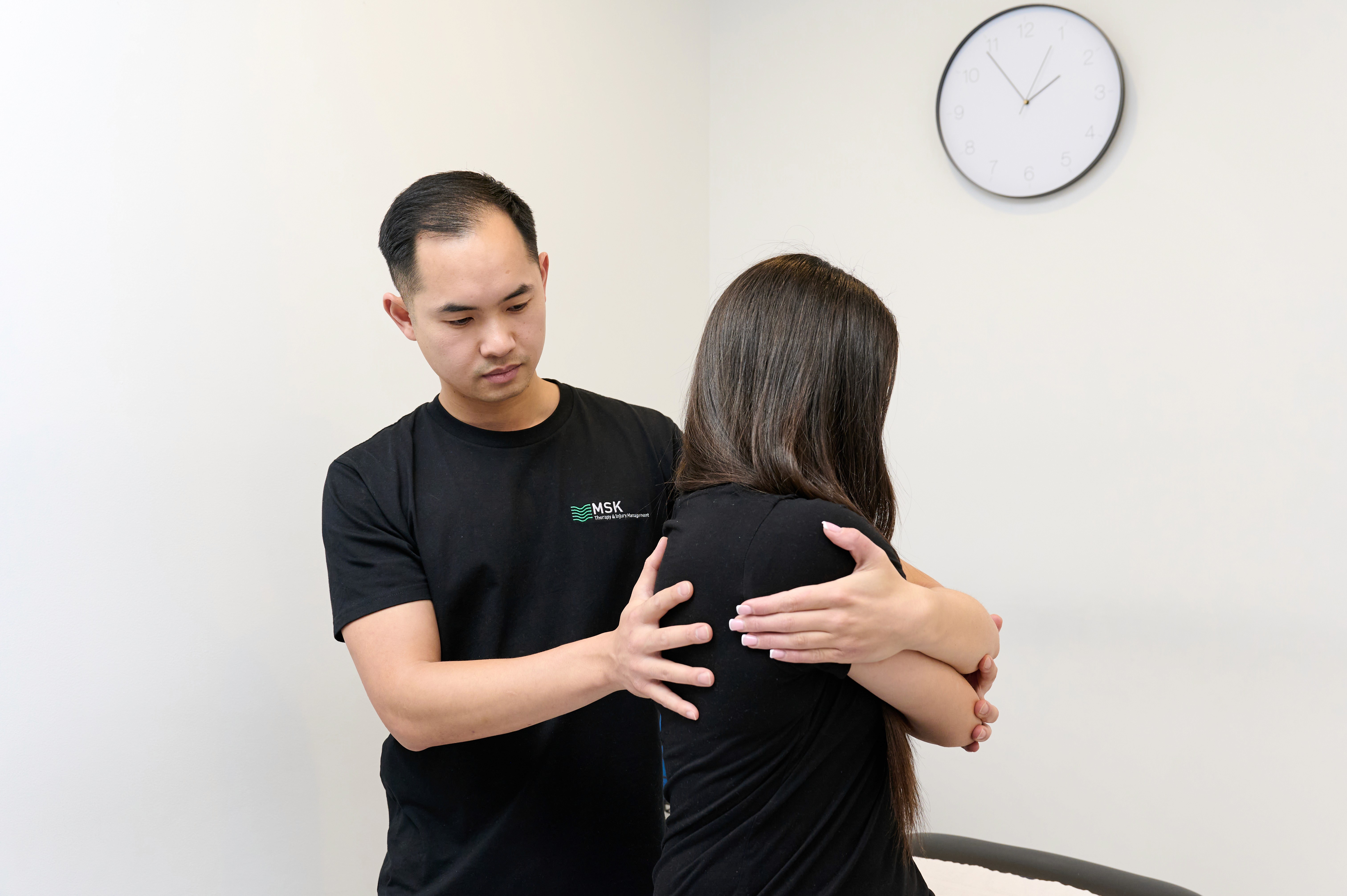 Chiropractor treating a patient's back and shoulder