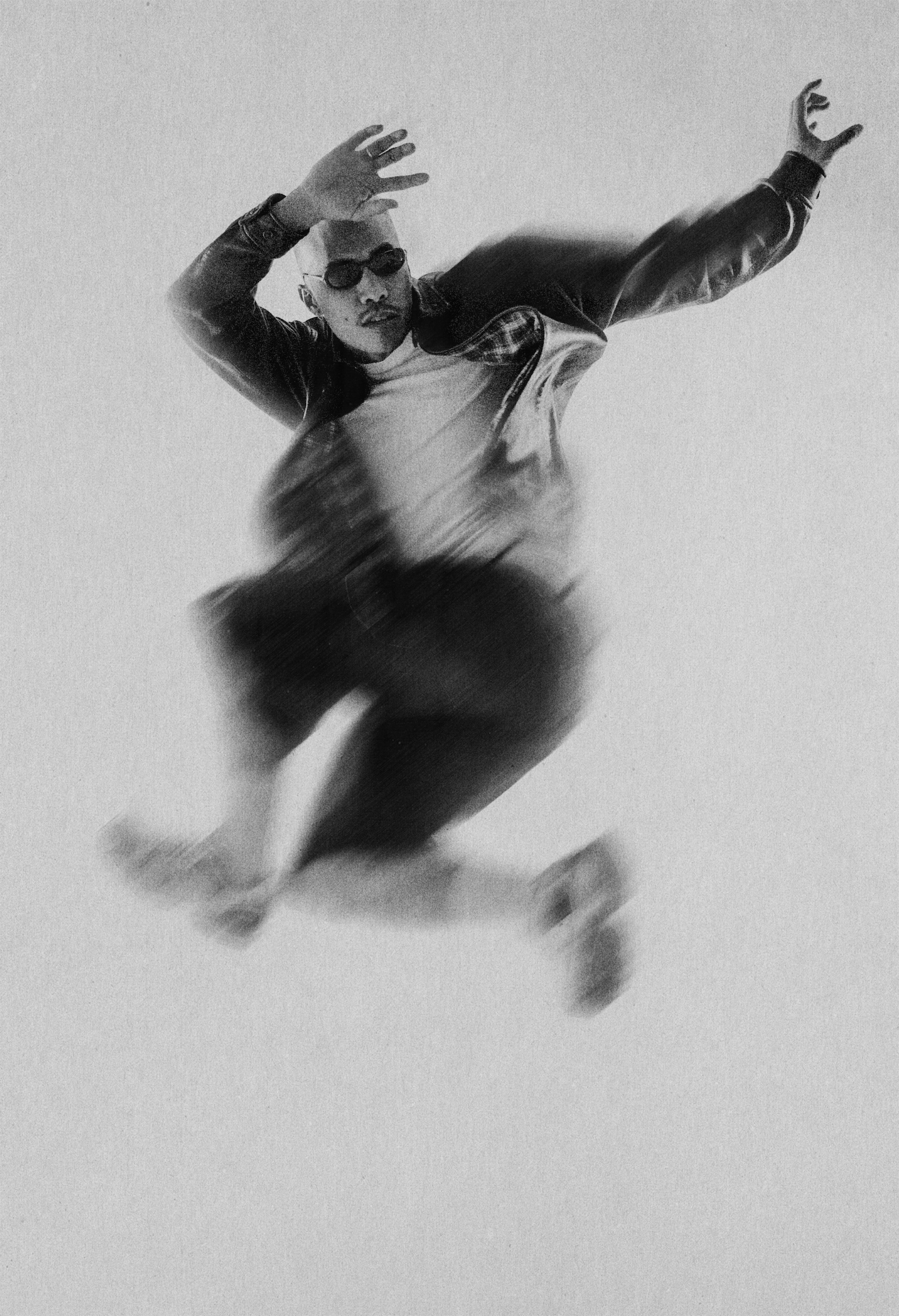 Man crouching next to a bicycle wheel.