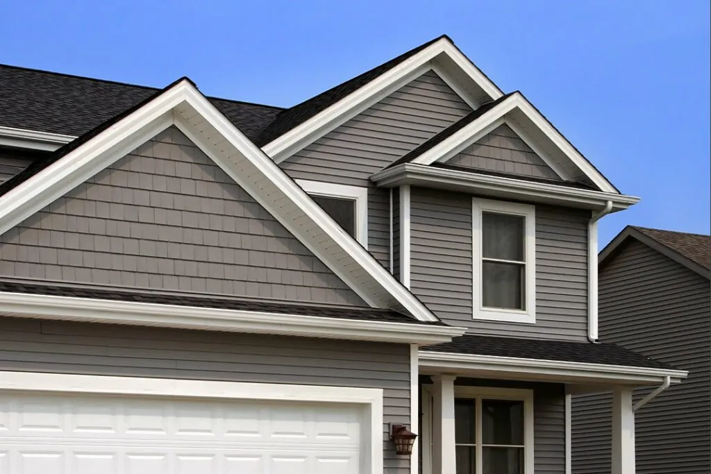 grey-vinyl-siding-with-gable-shakes-white-trim-calgary-home