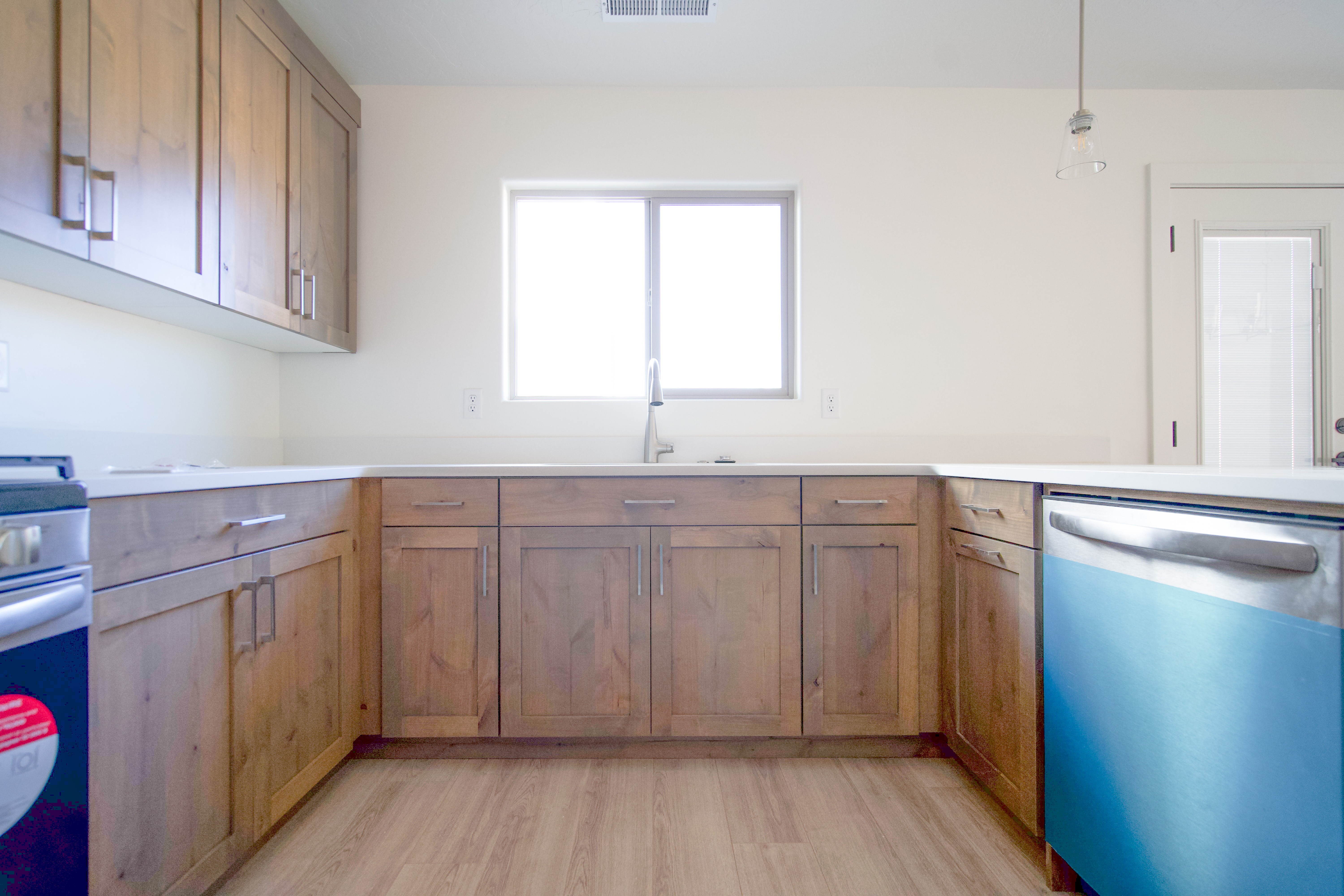 Updated kitchen featuring wood cabinets and light airy design in Southern Utah home.