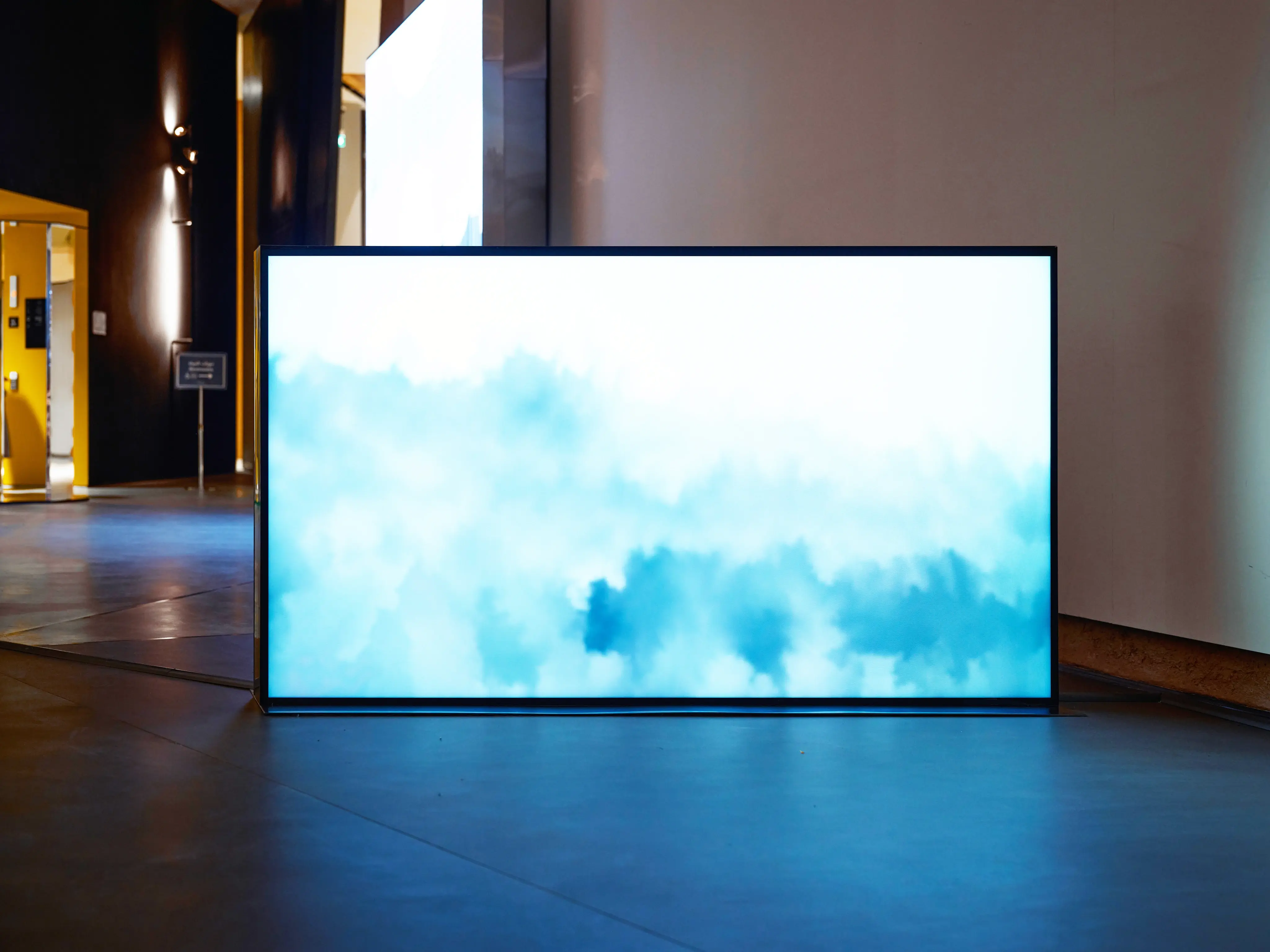 Large screen with abstract blue watercolor pattern