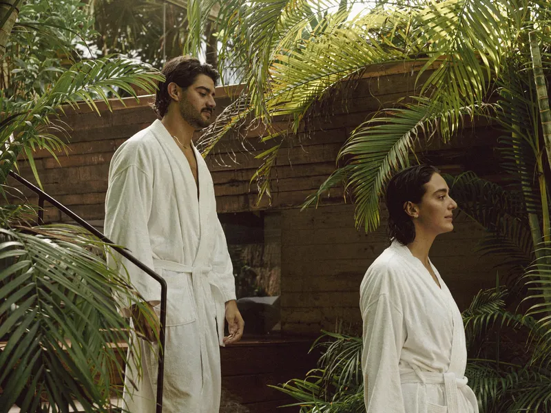 Yäan Spa at Be Tulum: two women relaxing after receiving a massage, with two hot tubs in the background overlooking the jungle.