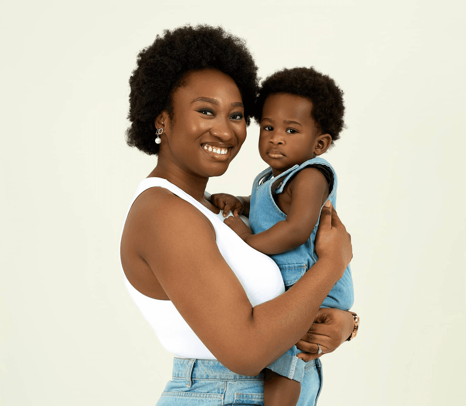 A heartwarming birthday photoshoot of a young boy celebrating with his mother in a luxurious studio in Dubai, capturing joyful moments, elegant styling, and a warm, intimate atmosphere.