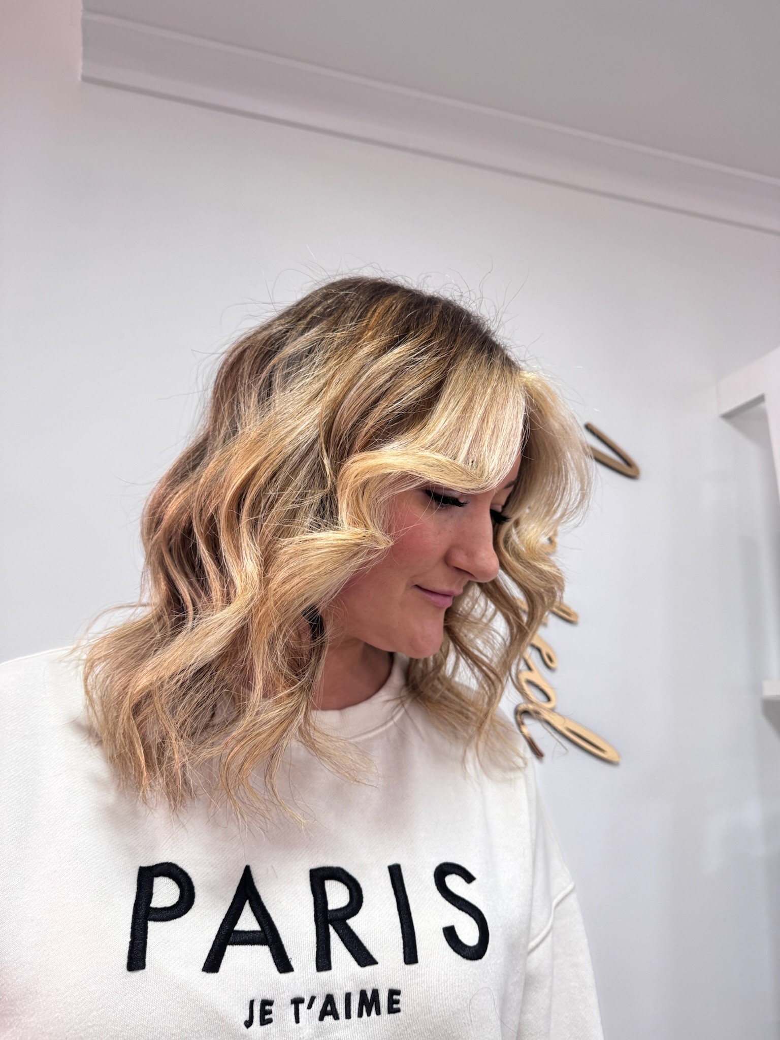 Woman with hair cut to shoulder length and with highlights