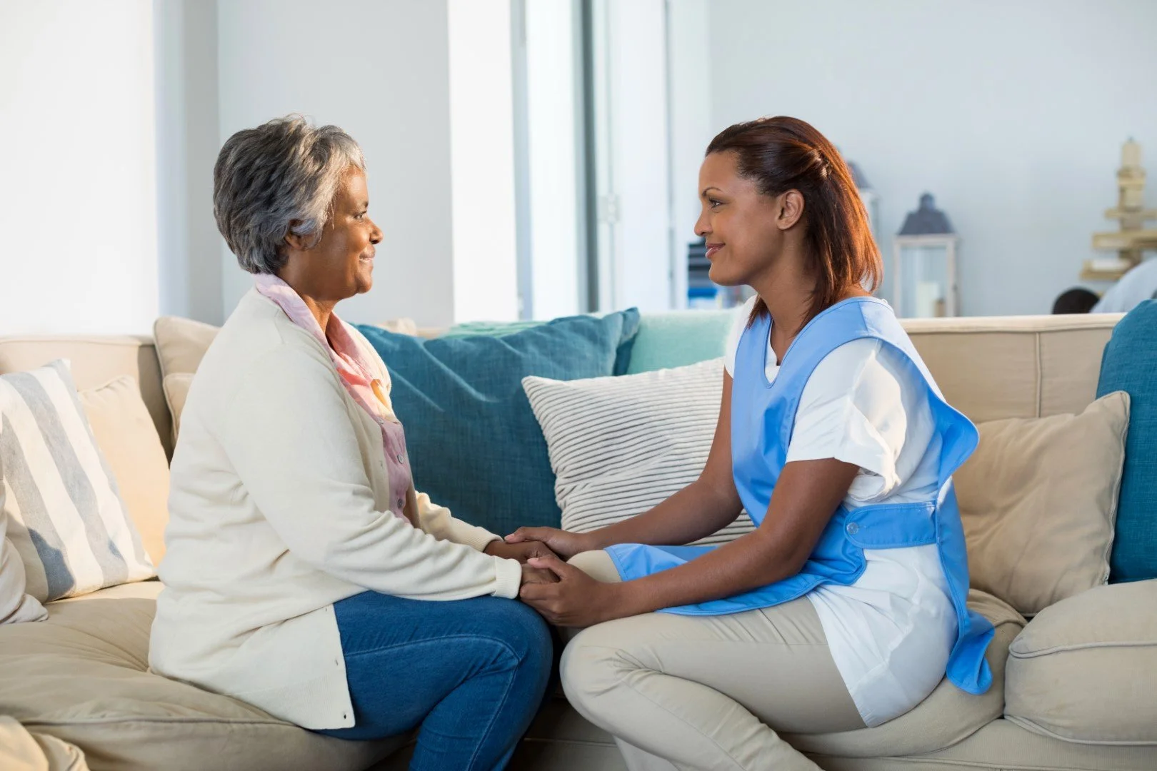 Caregiver assisting elderly couple with coloring