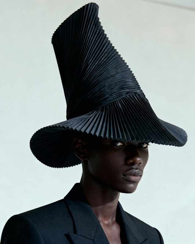 man wearing jacket near wall in room
