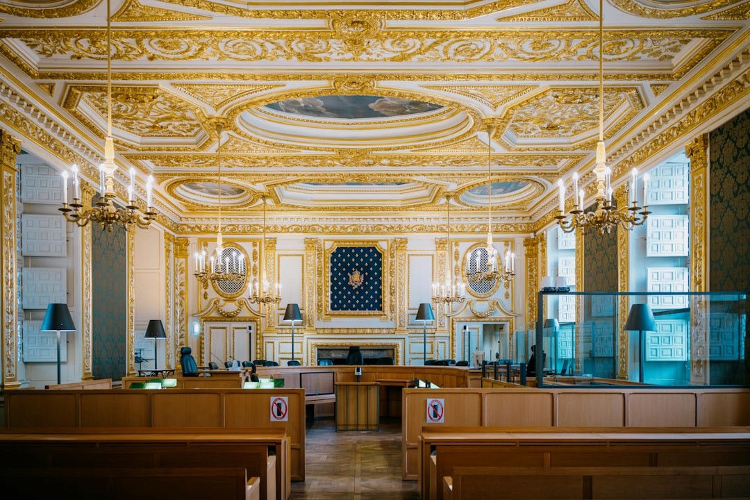 interior of a professional courtroom with judge bench and counsel tables - can a debt collection agency take you to court