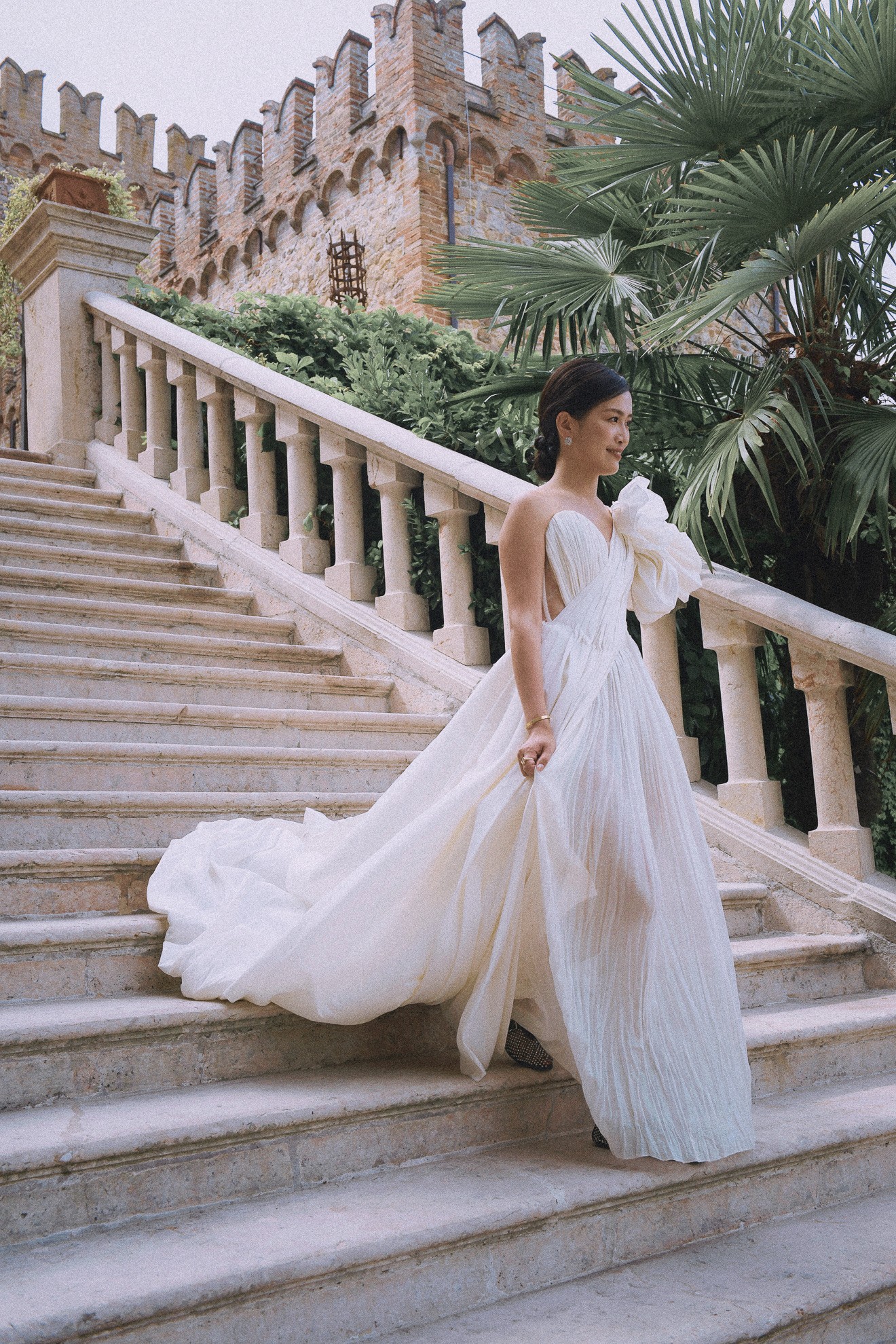 a black car driving down a street next to a motorcycle